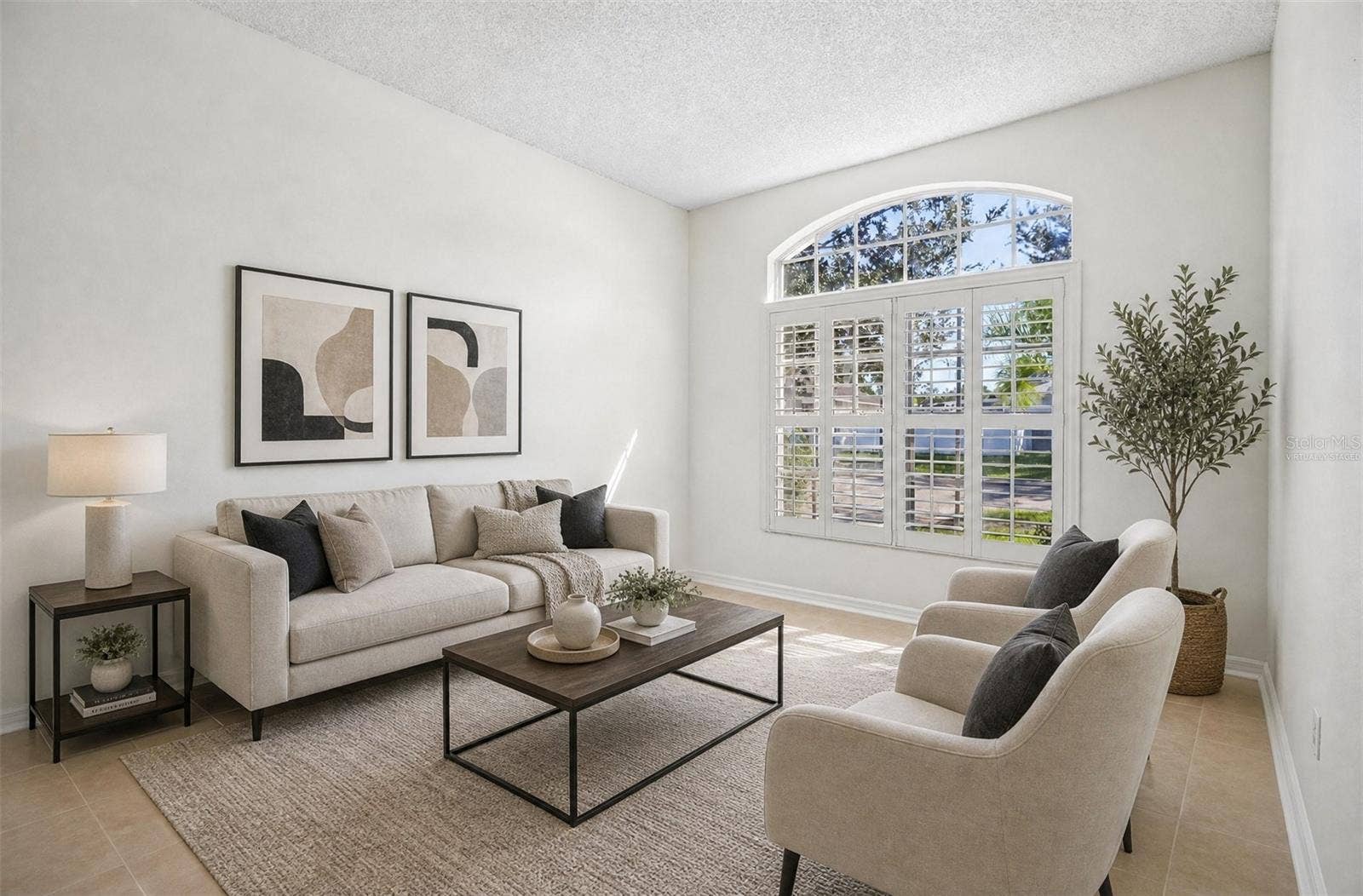 1806 ANNA CATHERINE DRIVE, Orlando, FL 32828 The formal Living Room greets you with an ELEGANT ARCHED-TOPPED WINDOW fitted with plantation shutters. Virtually Staged