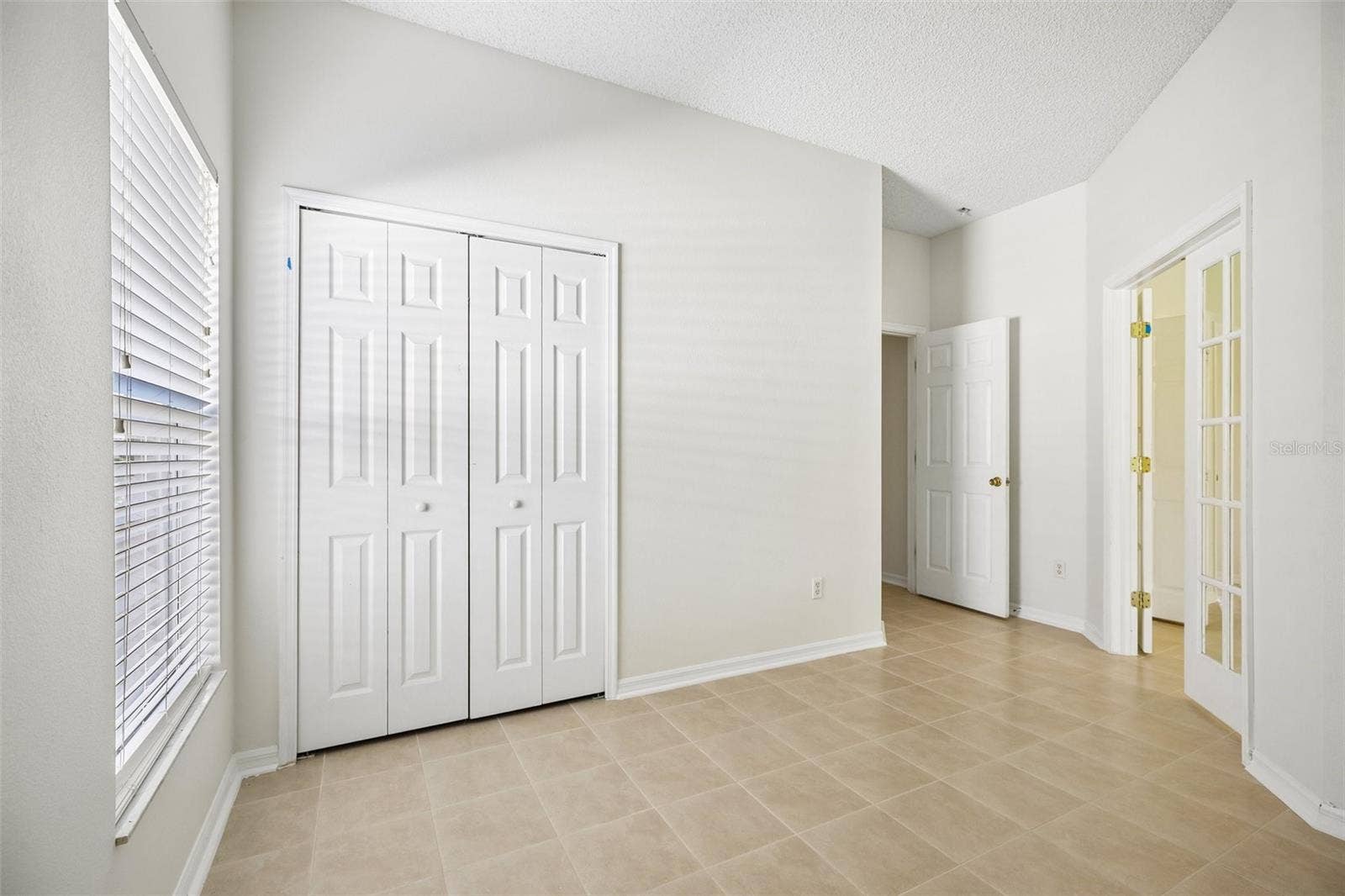 1806 ANNA CATHERINE DRIVE, Orlando, FL 32828 Glass-paneled French doors lead from the Primary Suite to a BONUS ROOM that could serve as a home office, nursery, hobby room, or POTENTIAL FOURTH BEDROOM, depending on your needs.