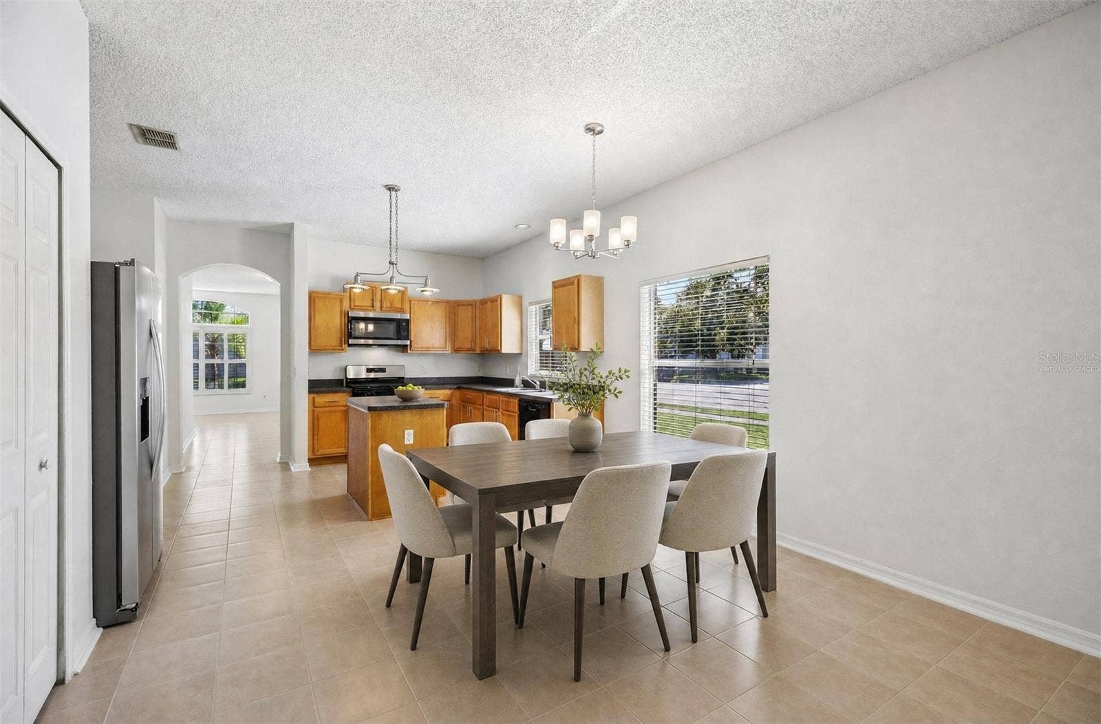 1806 ANNA CATHERINE DRIVE, Orlando, FL 32828 A Breakfast Nook in front of a LARGE PICTURE WINDOW, presents a bright spot for morning coffee or casual meals. Virtually Staged