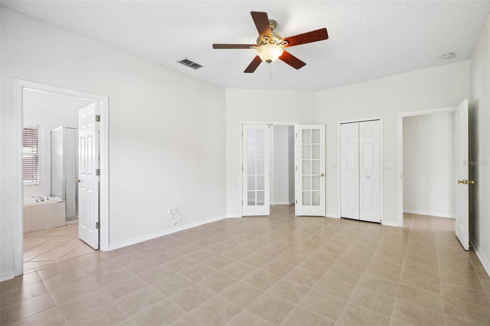 1806 ANNA CATHERINE DRIVE, Orlando, FL 32828 An especially VERSATILE FEATURE of the Primary Bedroom is the set of glass-paneled French doors leading to a Bonus Room.