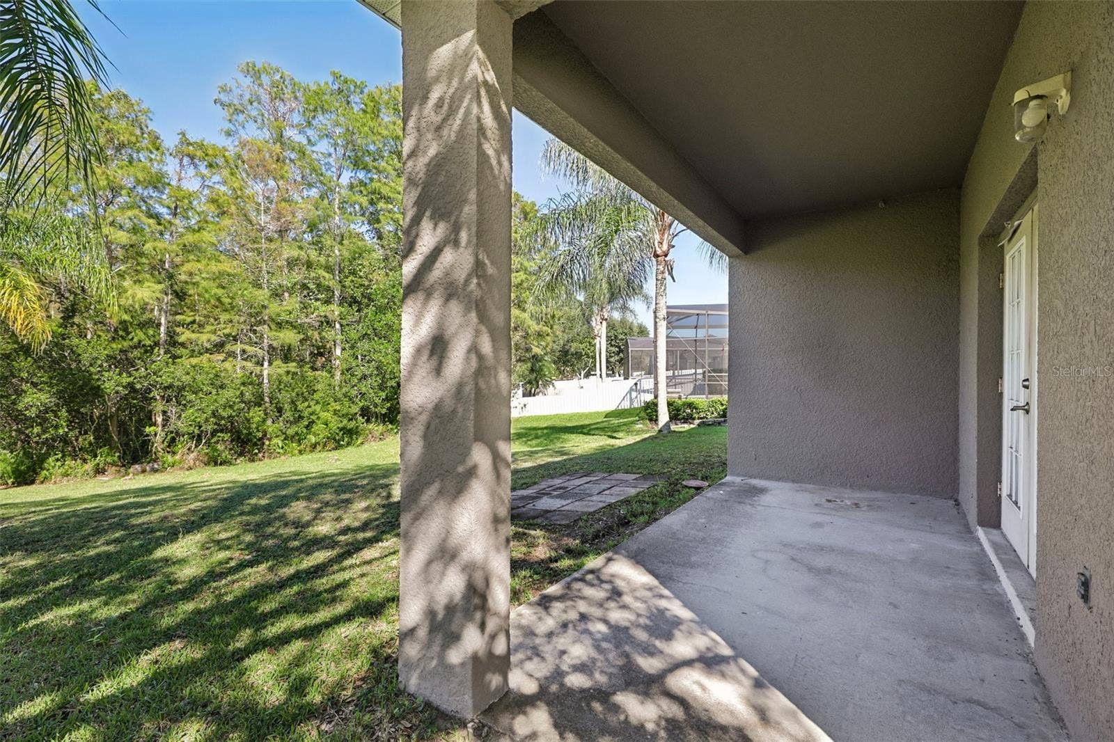 1806 ANNA CATHERINE DRIVE, Orlando, FL 32828 The covered backyard patio and EXPANSIVE OUTDOOR SPACE provide plenty of room to relax and enjoy the Florida lifestyle.