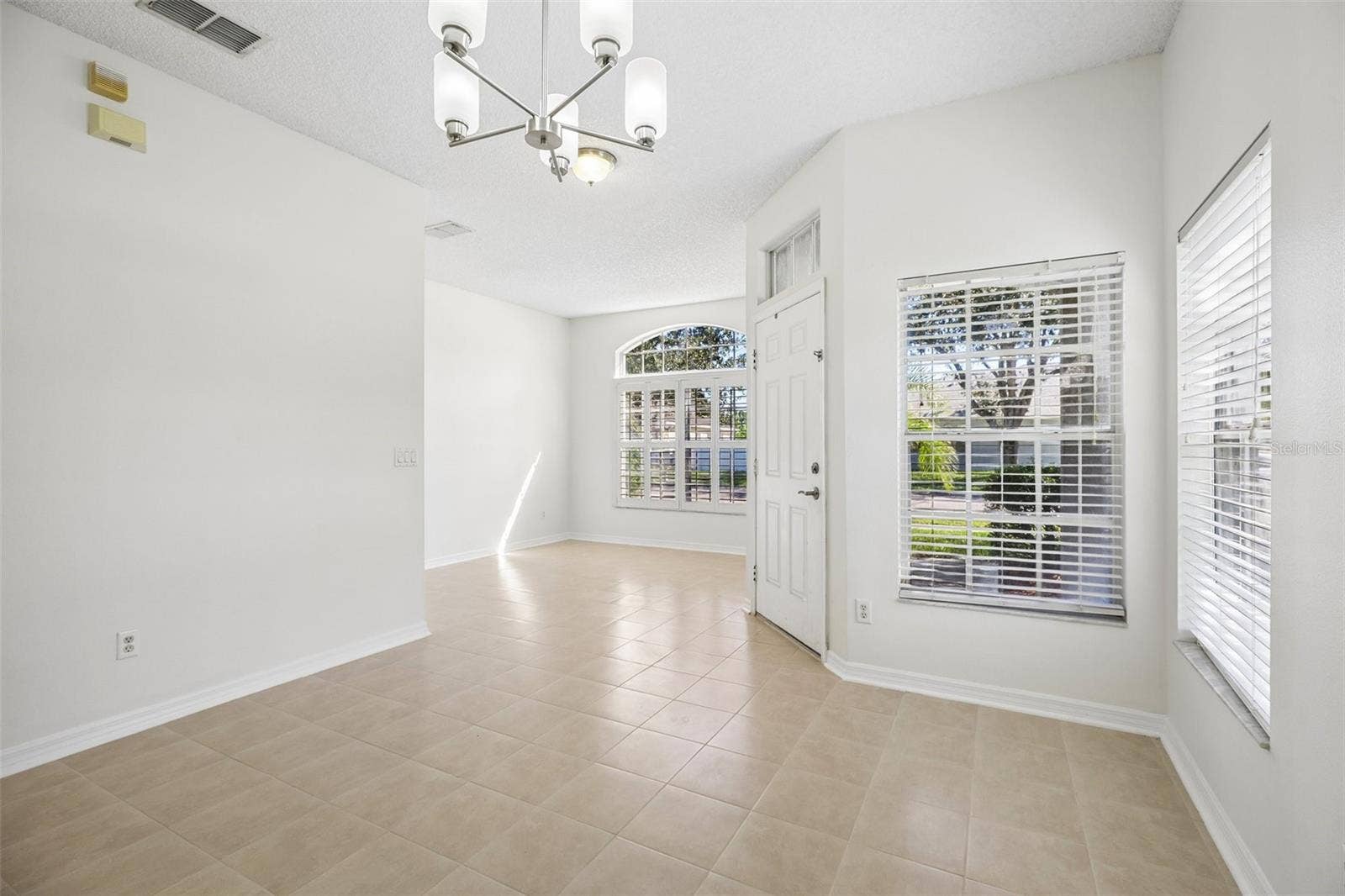1806 ANNA CATHERINE DRIVE, Orlando, FL 32828 The separate formal Dining Room sits on the opposite side of the foyer, overlooking the front yard.