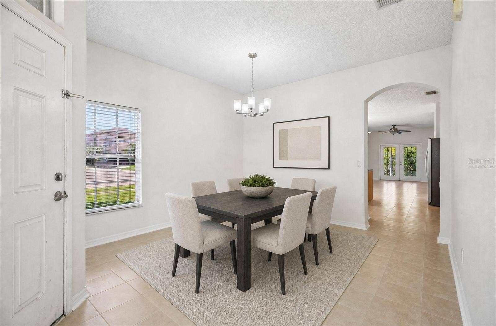 1806 ANNA CATHERINE DRIVE, Orlando, FL 32828 The separate formal Dining Room sits on the opposite side of the foyer, overlooking the front yard. Virtually Staged