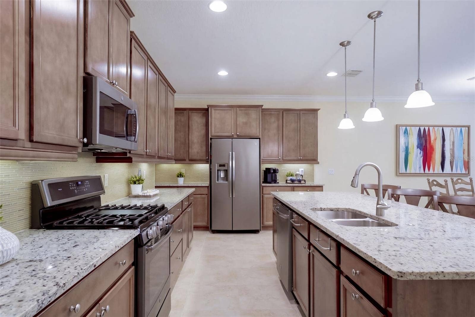 1233 EGGLESTON DRIVE, Deland, FL 32724 Kitchen w/ a 5-burner natural gas convention range, stainless steel appliances & pendant lighting above breakfast island