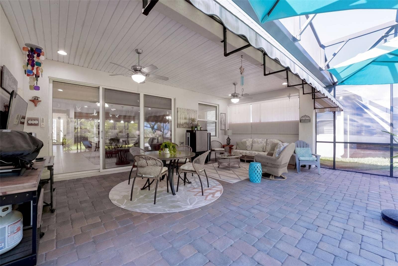 1233 EGGLESTON DRIVE, Deland, FL 32724 Screen enclosed covered Lanai w/ 2 ceiling fans, recessed lighting & a wall mounted flat screen TV