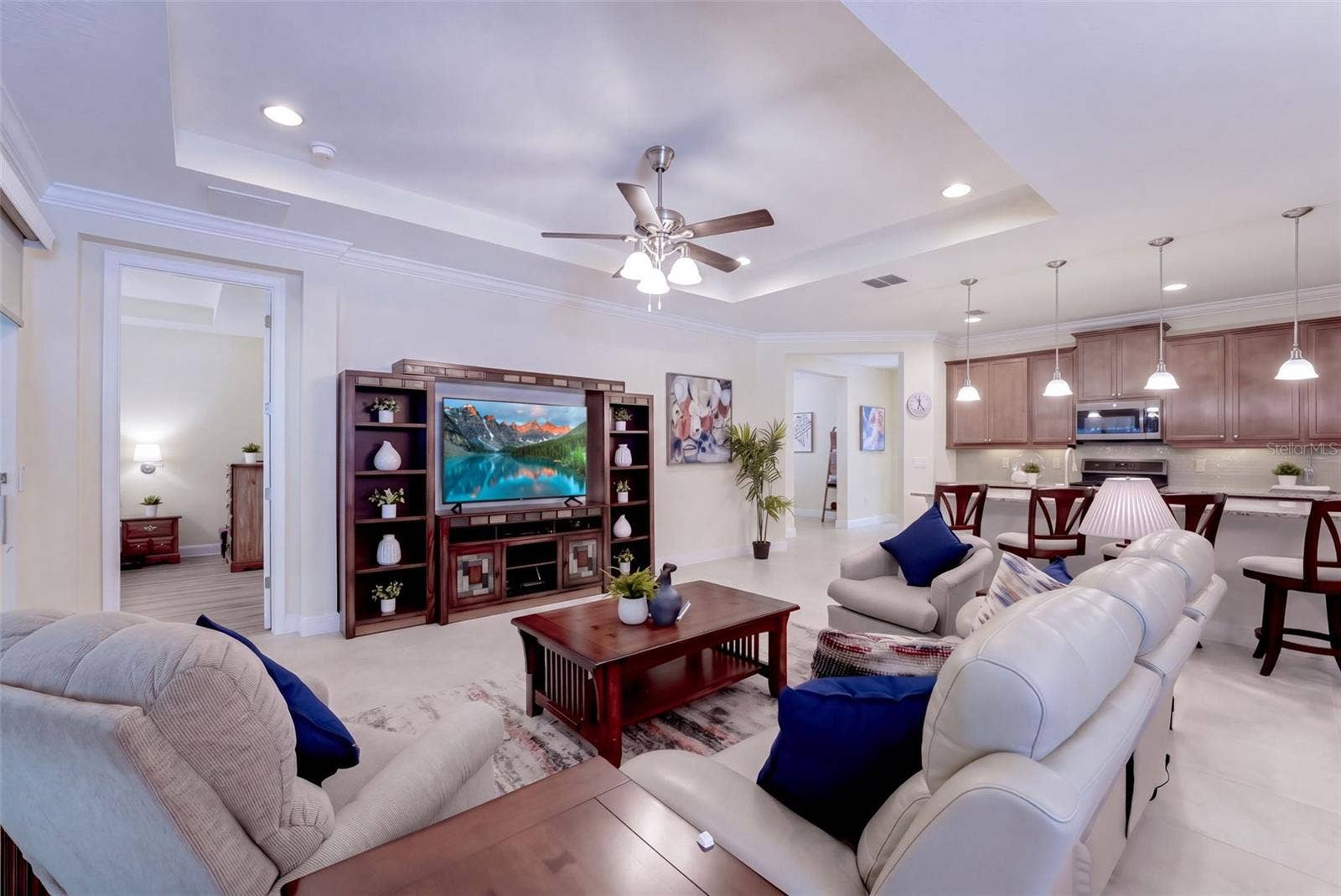 1233 EGGLESTON DRIVE, Deland, FL 32724 Great Room w/ crown molding, recessed lighting, tray ceiling & a ceiling fan