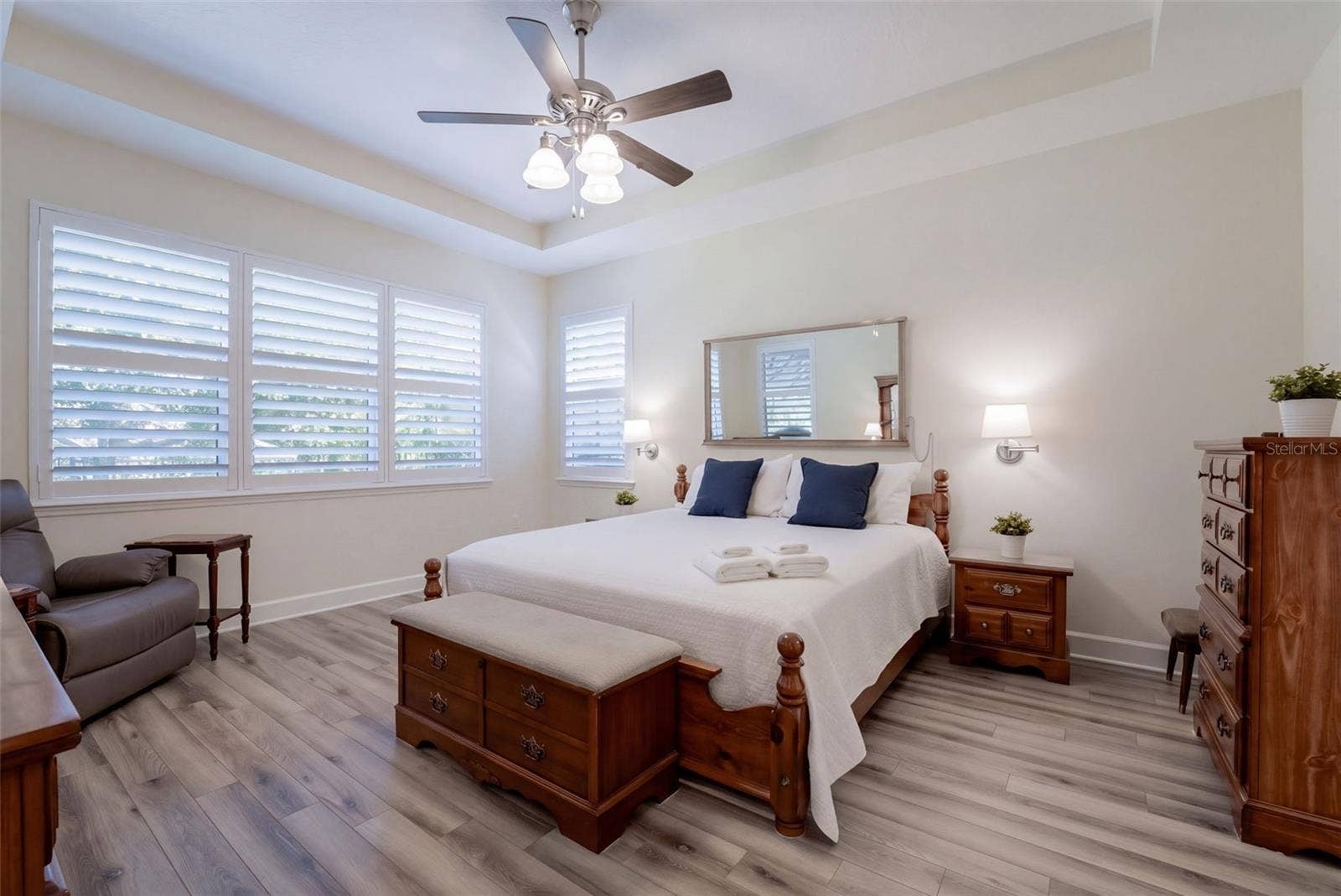 1233 EGGLESTON DRIVE, Deland, FL 32724 14' x 17' Primary Bedroom w/ a luxury vinyl floor, tray ceiling & a ceiling fan