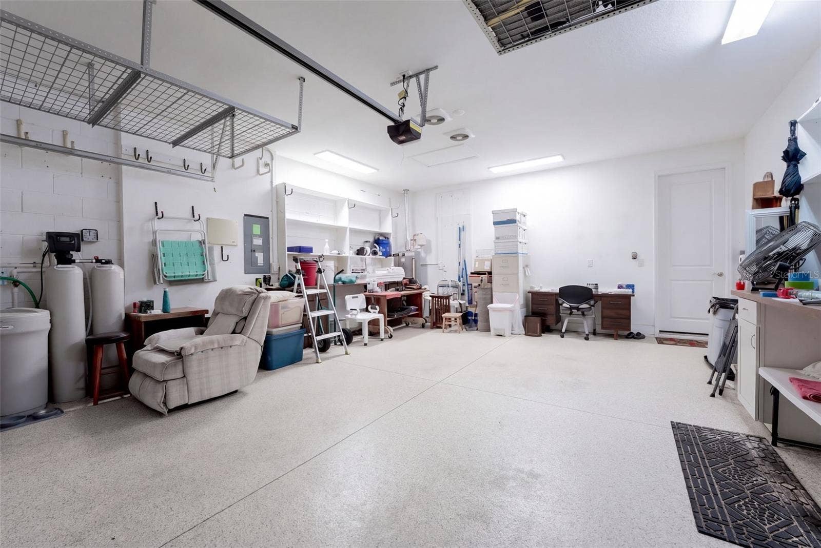 1233 EGGLESTON DRIVE, Deland, FL 32724 19' x 23' Garage w/ epoxy floor, exhaust fans for ventilation, water softener, storage racks & additional lighting
