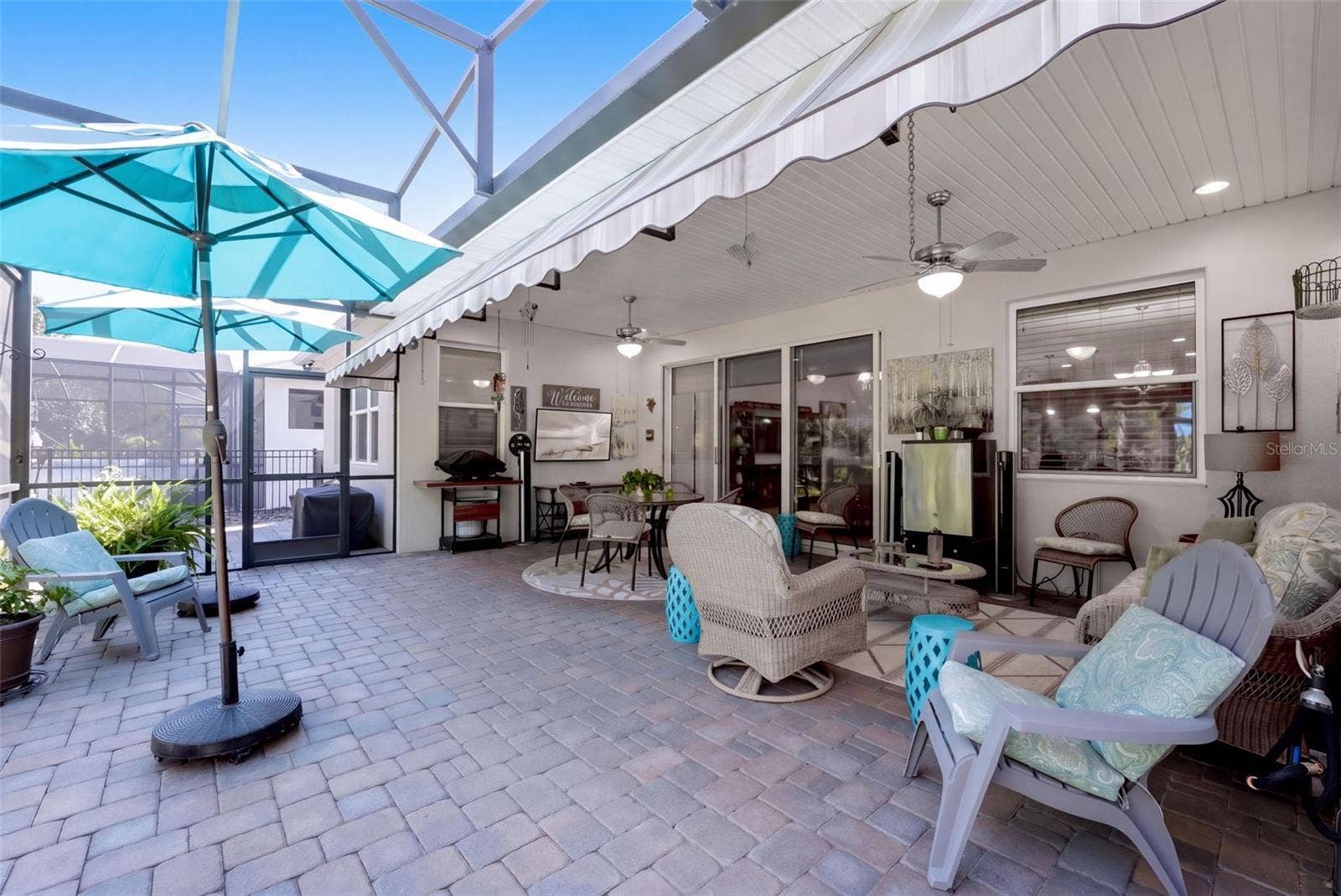 1233 EGGLESTON DRIVE, Deland, FL 32724 Screen enclosed covered Lanai w/ brick pavers & a wall mounted flat screen TV