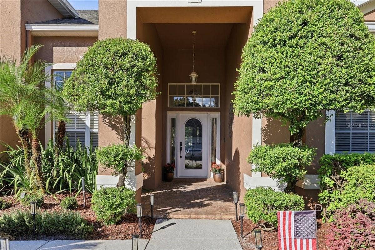 Manicured landscaping, covered front entry.