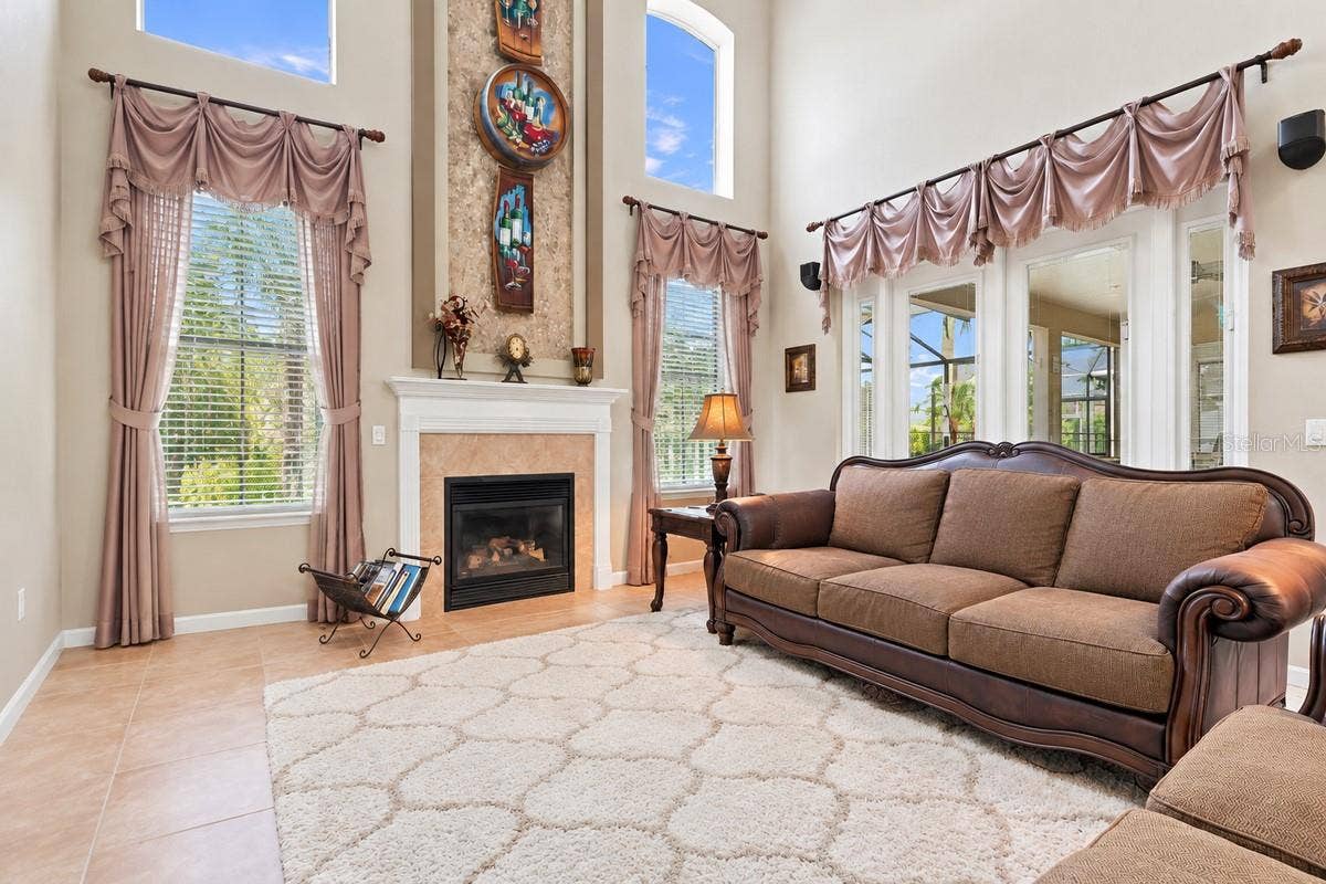 Two story living room is anchored by the fireplace feature wall.