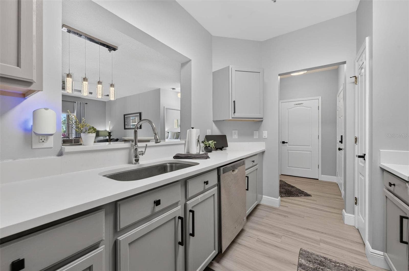 Kitchen sink and pendant lights over dining area