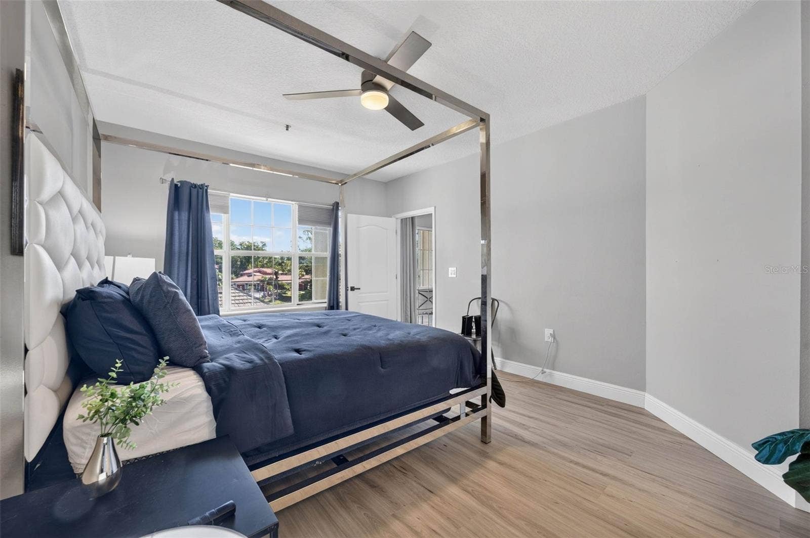 Primary bedroom with window and ceiling fan