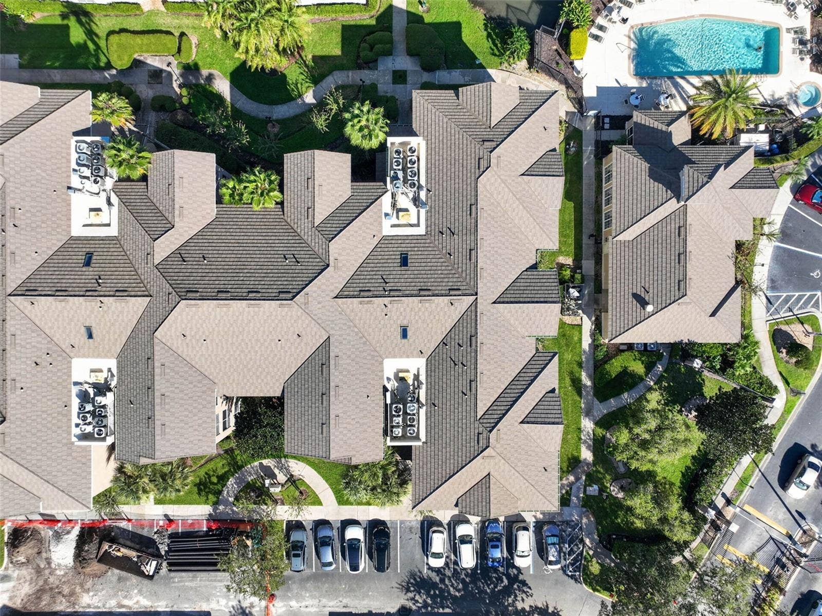 Top-down aerial of tile roof and community pool