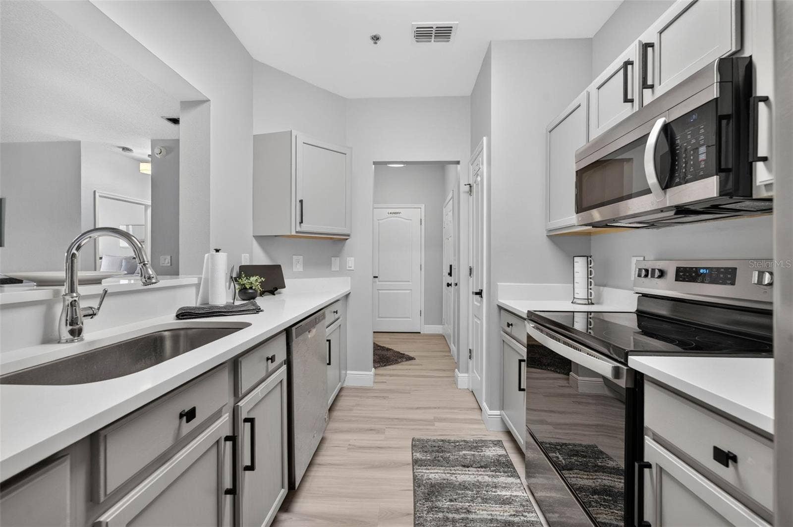Kitchen sink with hallway beyond