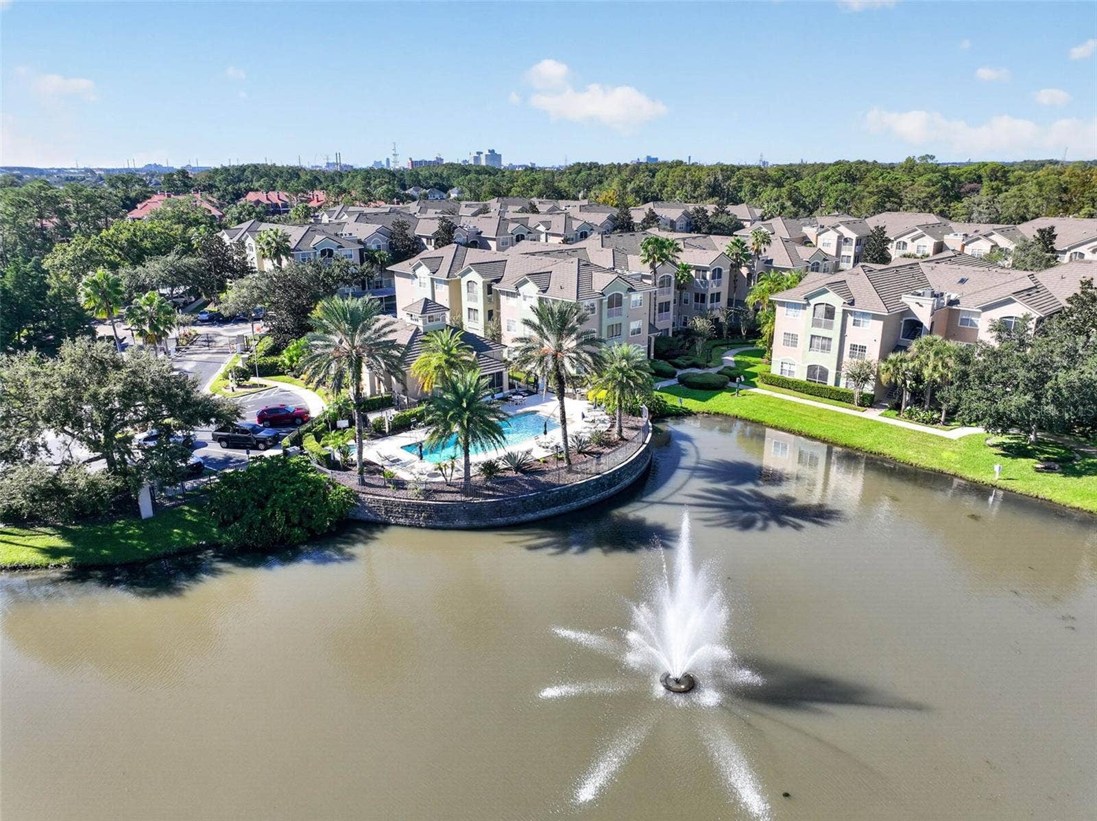 Aerial of community pool and pond fountain