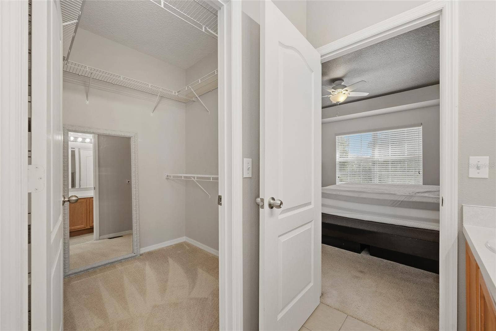 Primary bedroom walk in closet