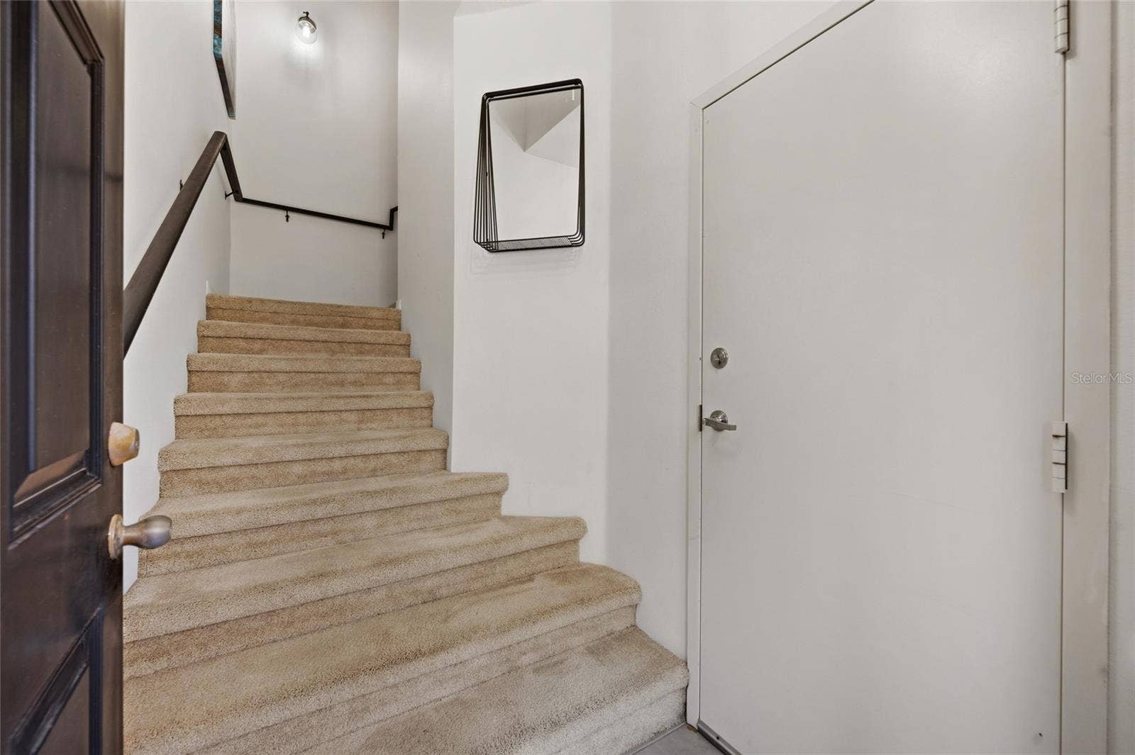 stairs leading up to living area.  Garage door coming into home