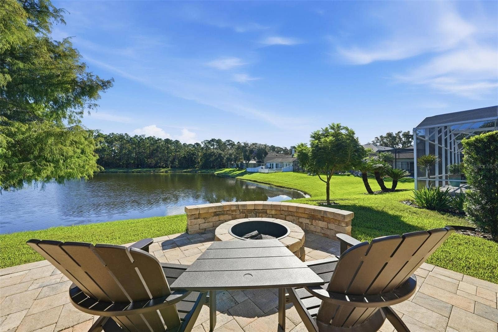 FIRE PIT ON THE PATIO OVER LOOKING THE POND WITH BUILT IN SEATING. LOOK AT THAT VIEW!