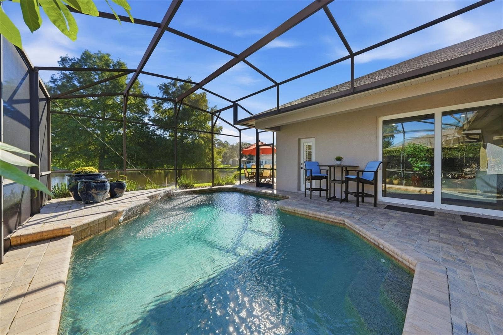 LOVELY POOL WITH PAVER COPING AND LANAI