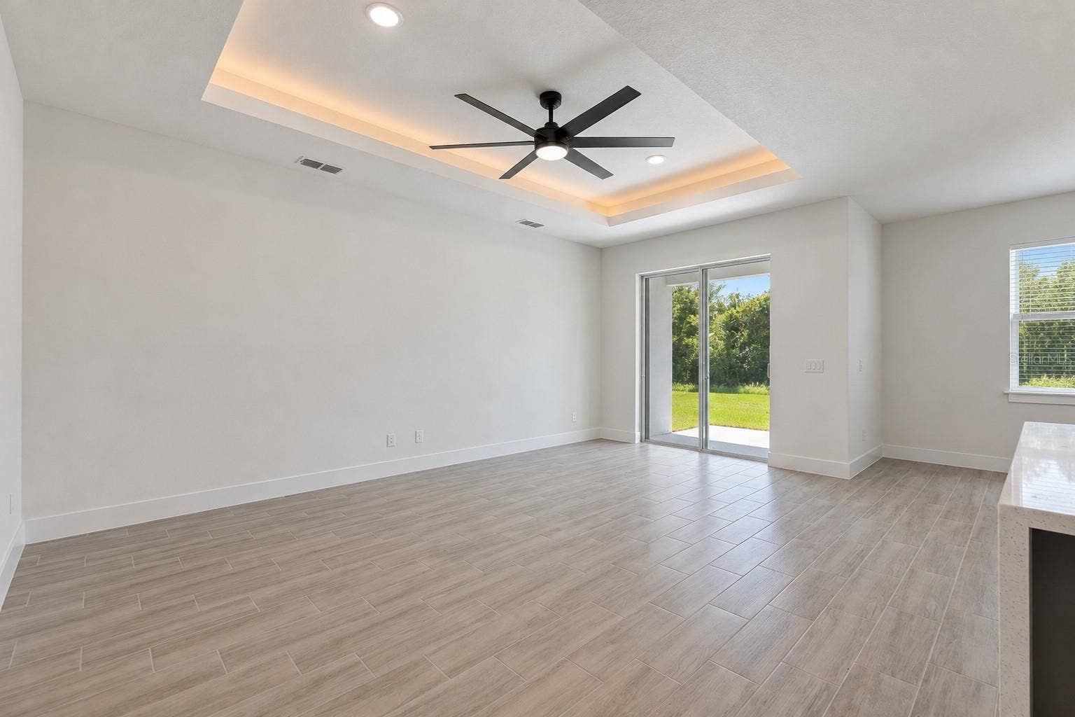 24479 SW KINGSWAY CIRCLE, Arcadia, FL 34269 Living room. Digitally edited model/property composite.