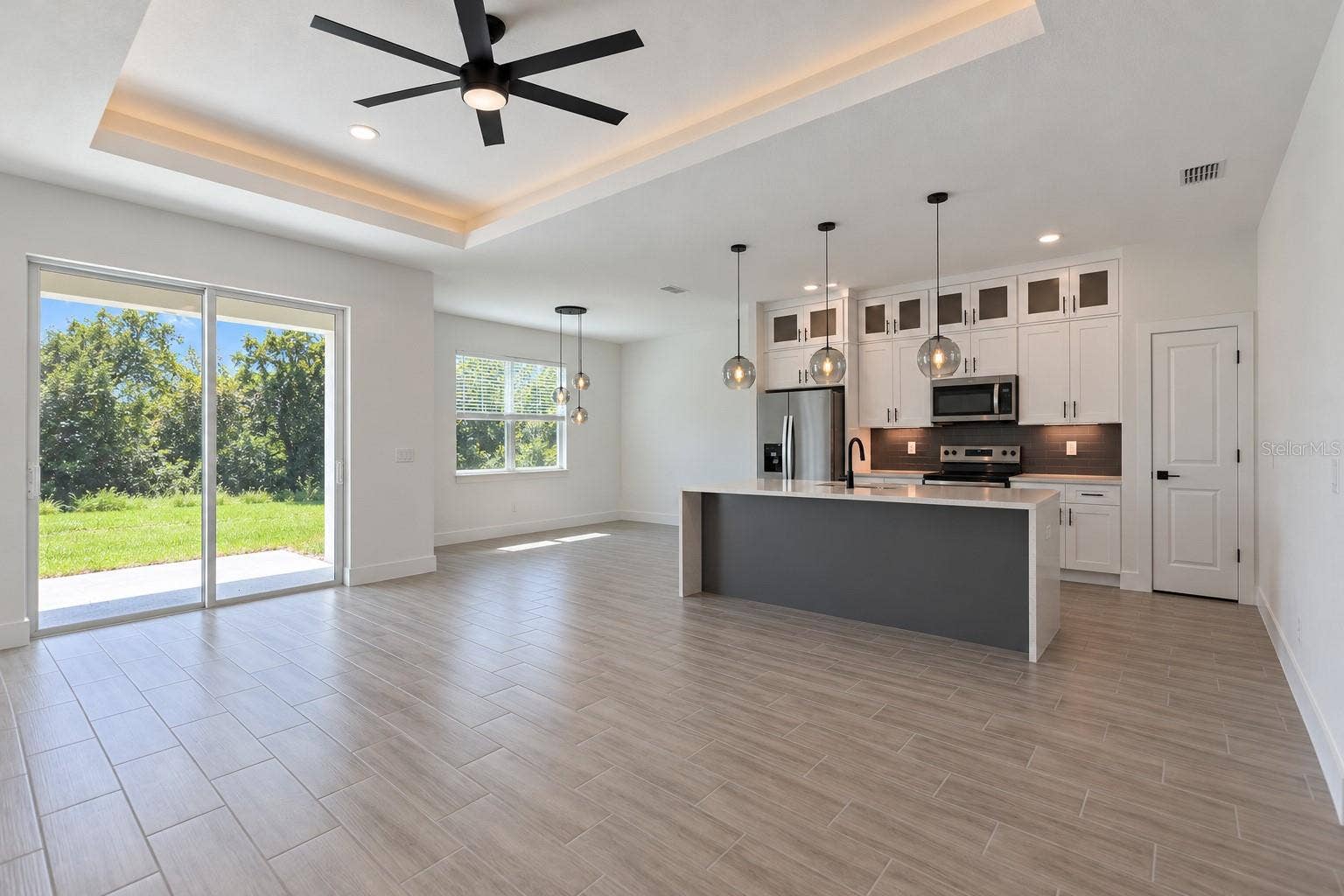 24479 SW KINGSWAY CIRCLE, Arcadia, FL 34269 Open living and kitchen. Digitally edited model/property composite.