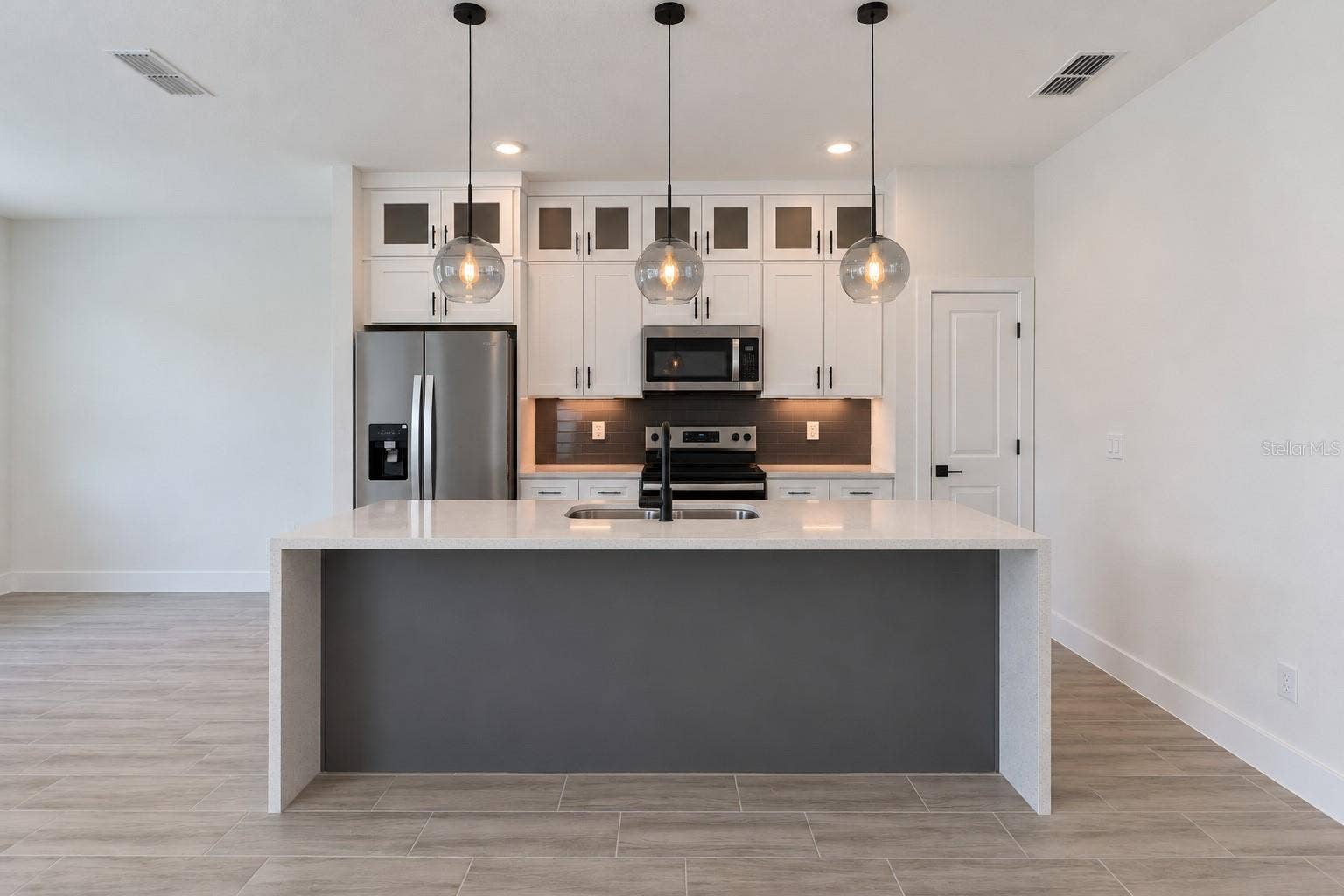 24479 SW KINGSWAY CIRCLE, Arcadia, FL 34269 Kitchen front view. Digitally edited model/property composite.