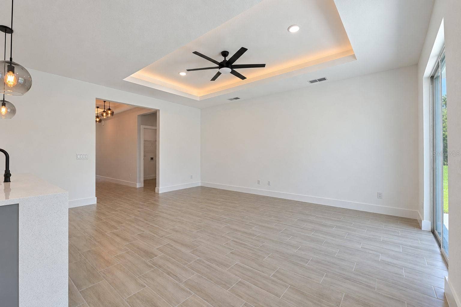 24479 SW KINGSWAY CIRCLE, Arcadia, FL 34269 Living room reverse view. Digitally edited model/property composite.