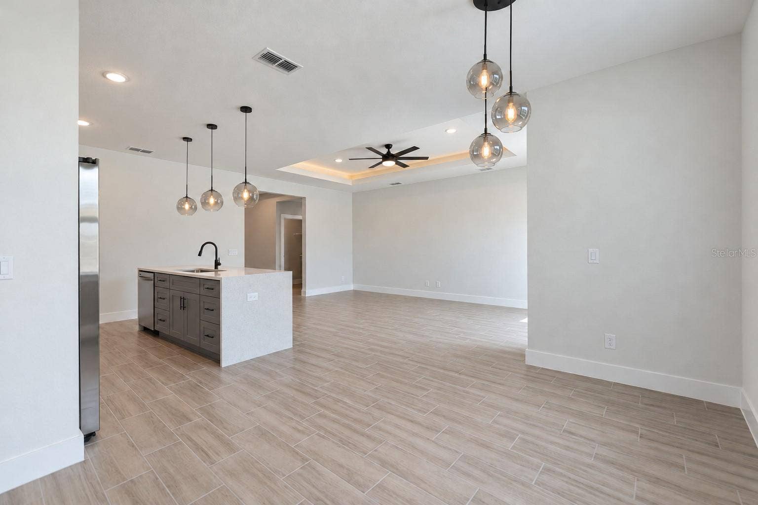 24479 SW KINGSWAY CIRCLE, Arcadia, FL 34269 Dining toward living. Digitally edited model/property composite.