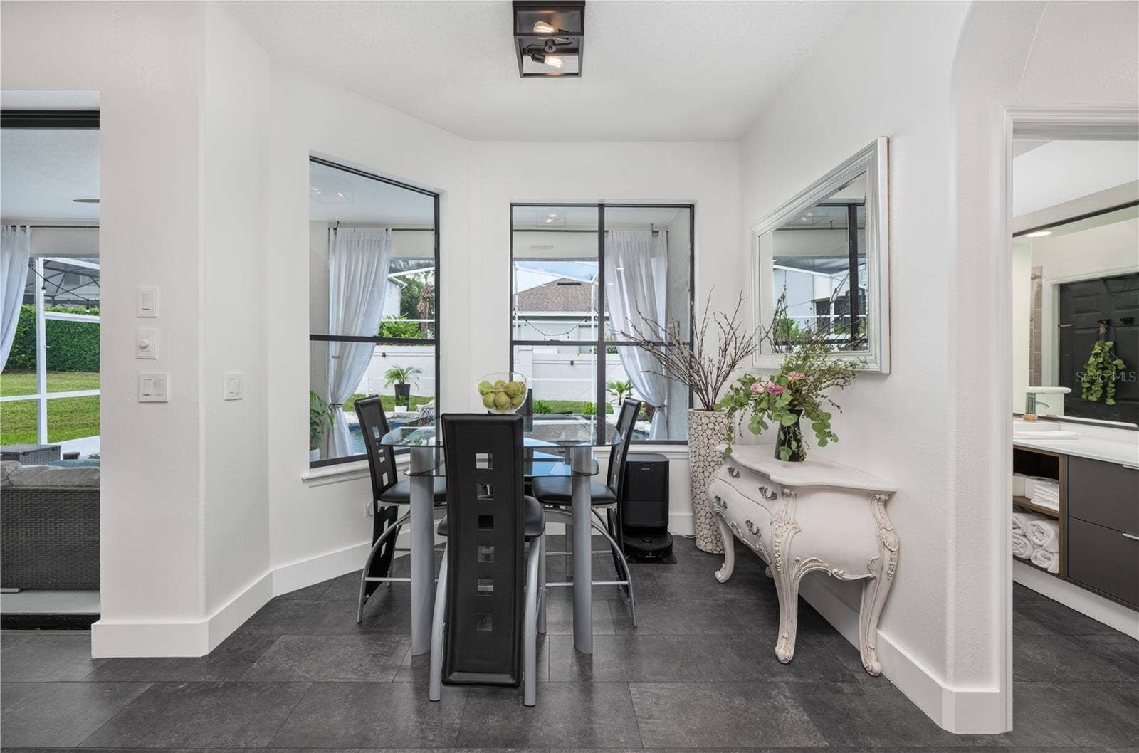 1854 VISTA ROYALE BOULEVARD, Orlando, FL 32835 Bright and inviting breakfast nook with a picturesque view of the pool.