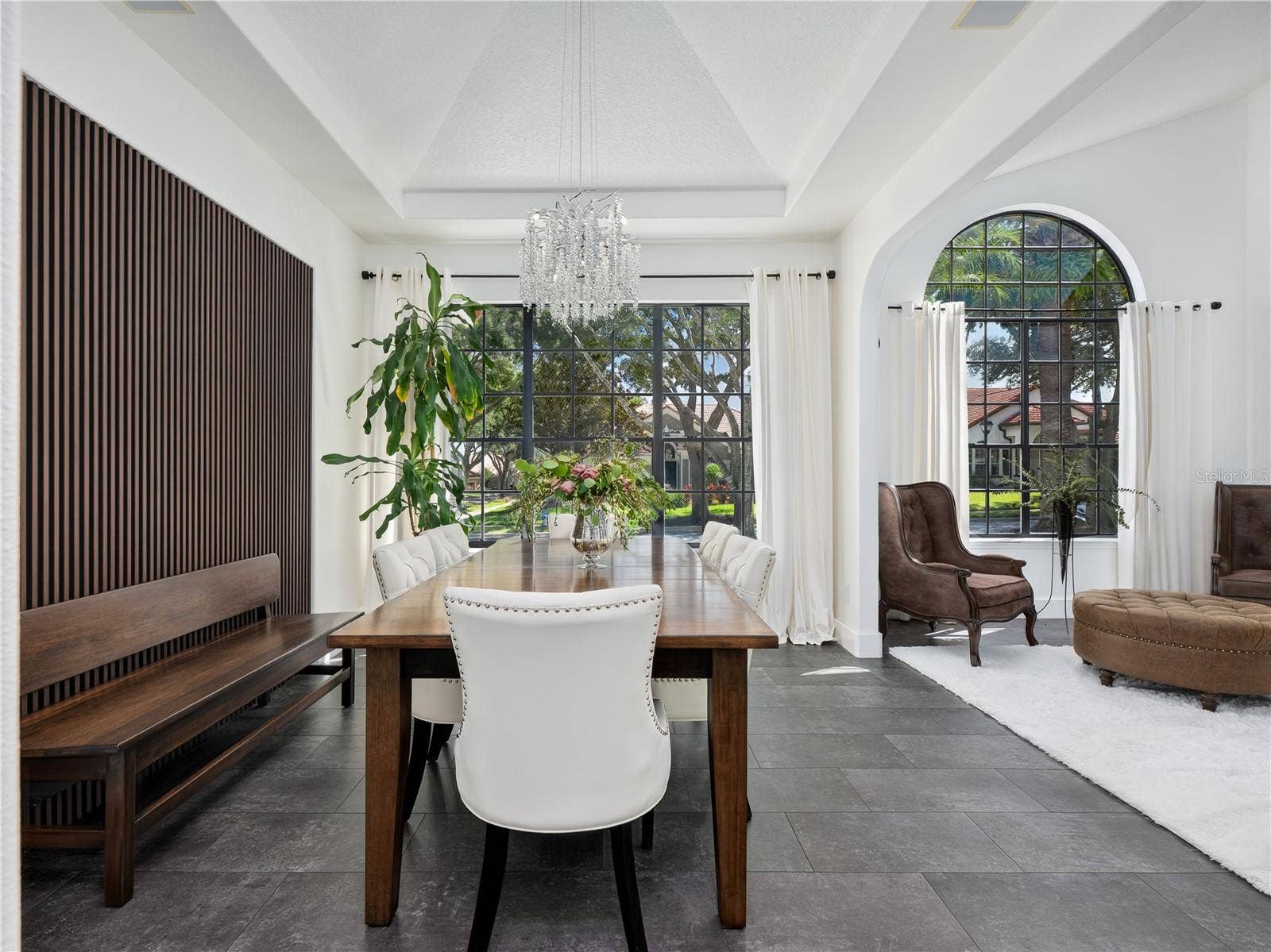 1854 VISTA ROYALE BOULEVARD, Orlando, FL 32835 Architectural wood panels serve as the perfect backdrop for this stunning dining room.
