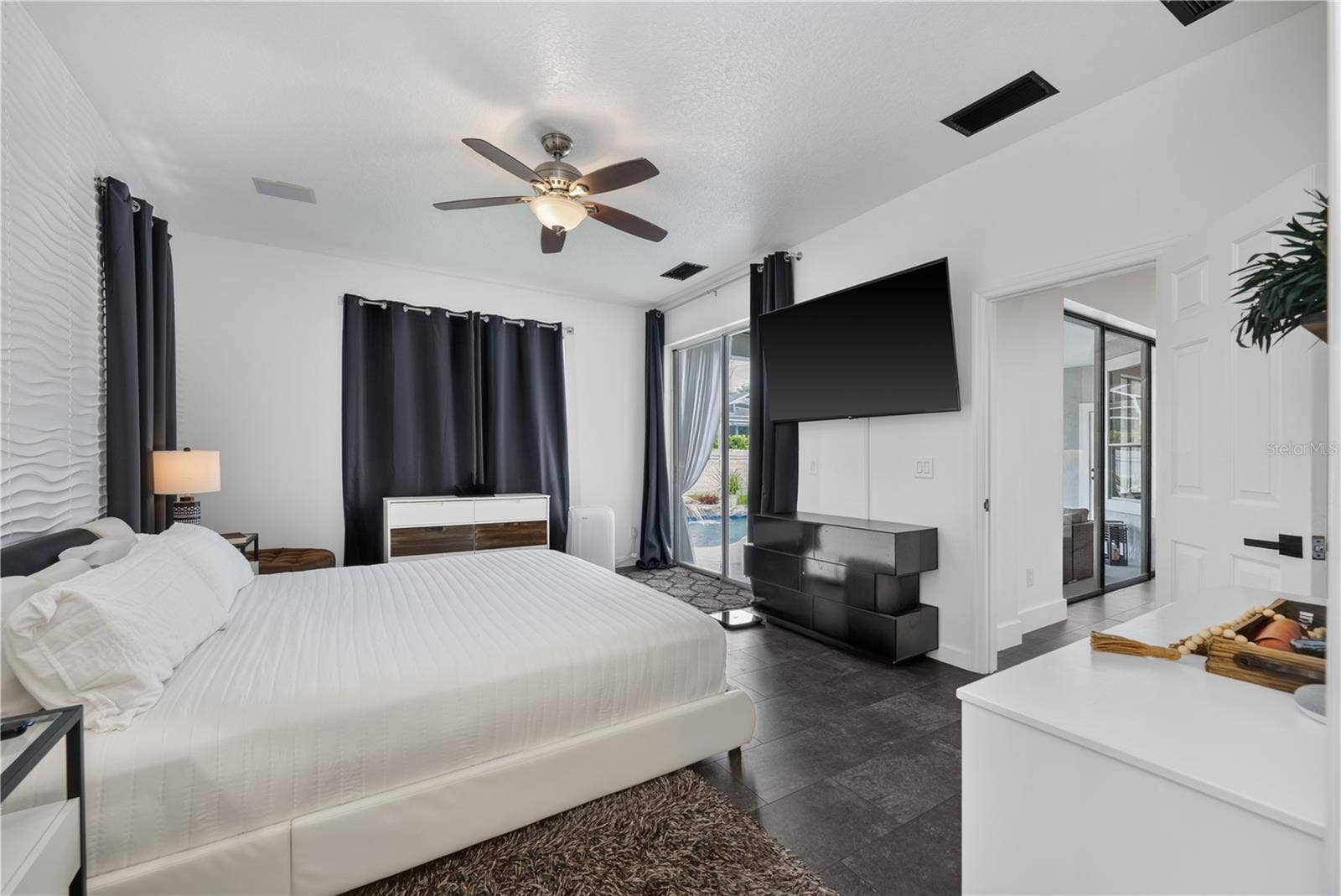 1854 VISTA ROYALE BOULEVARD, Orlando, FL 32835 Spacious primary bedroom with a scenic view of the pool.