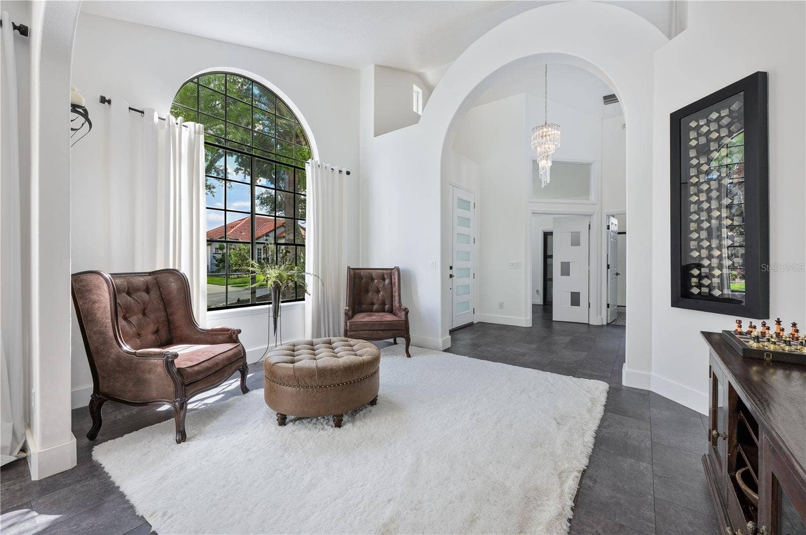1854 VISTA ROYALE BOULEVARD, Orlando, FL 32835 This formal living room is a standout feature of the home, providing an elegant space for relaxation and the perfect backdrop for a holiday tree.