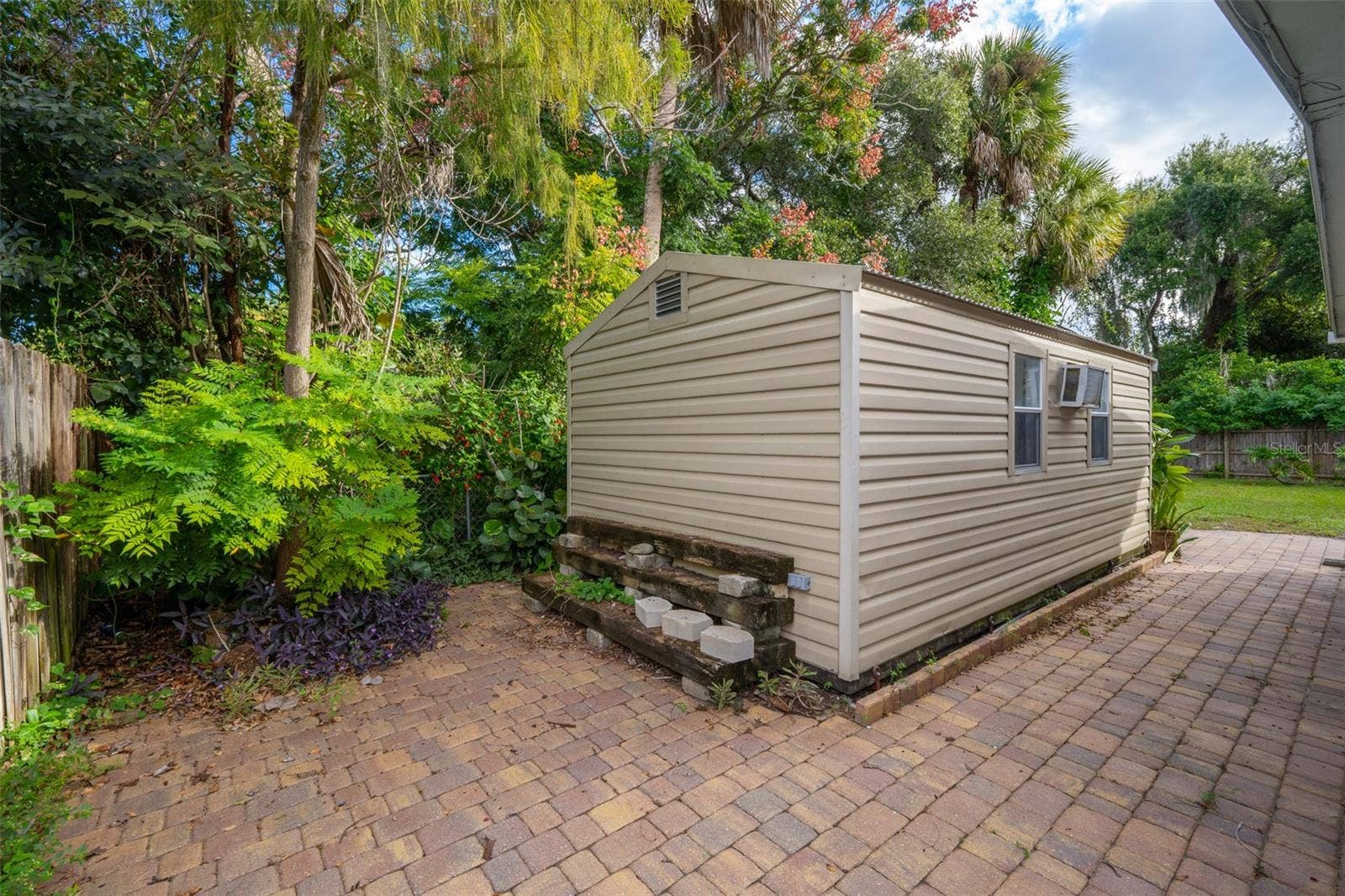 638 ORANGE COURT, Rockledge, FL 32955 Shed with Wall AC on Paver Patio
