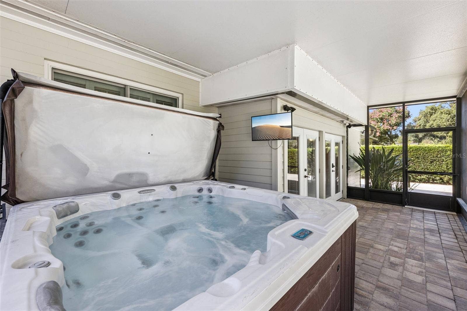 3115 HARGILL DRIVE, Orlando, FL 32806 Large Screen porch with hot tub is right off the bar area.