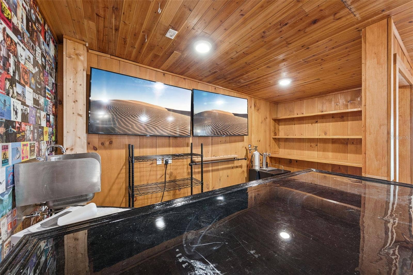 3115 HARGILL DRIVE, Orlando, FL 32806 Looking into the bar area with fixed shelving, epoxy bartop and sink with 2 flat screen tv's included. Everything you need to start watching the big game!