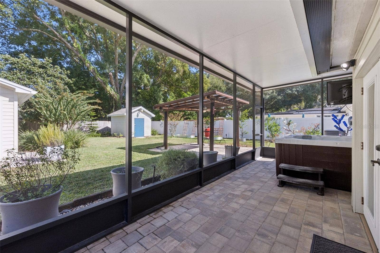 3115 HARGILL DRIVE, Orlando, FL 32806 Screen porch views overlooking the hot tub and fully fenced backyard.