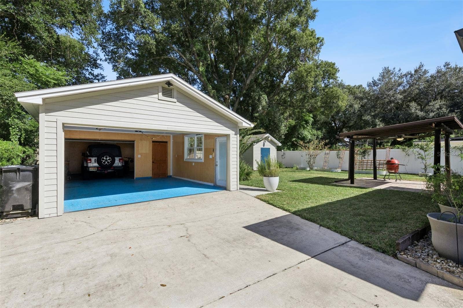 3115 HARGILL DRIVE, Orlando, FL 32806 Views of the garage, gazebo and grass area.
