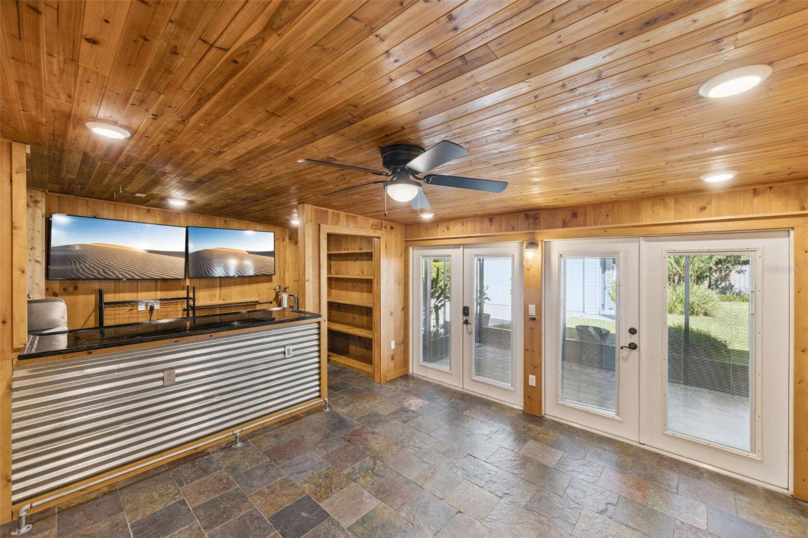 3115 HARGILL DRIVE, Orlando, FL 32806 Gameroom has 2 sets of French doors that open into a large screen porch and private fenced backyard.