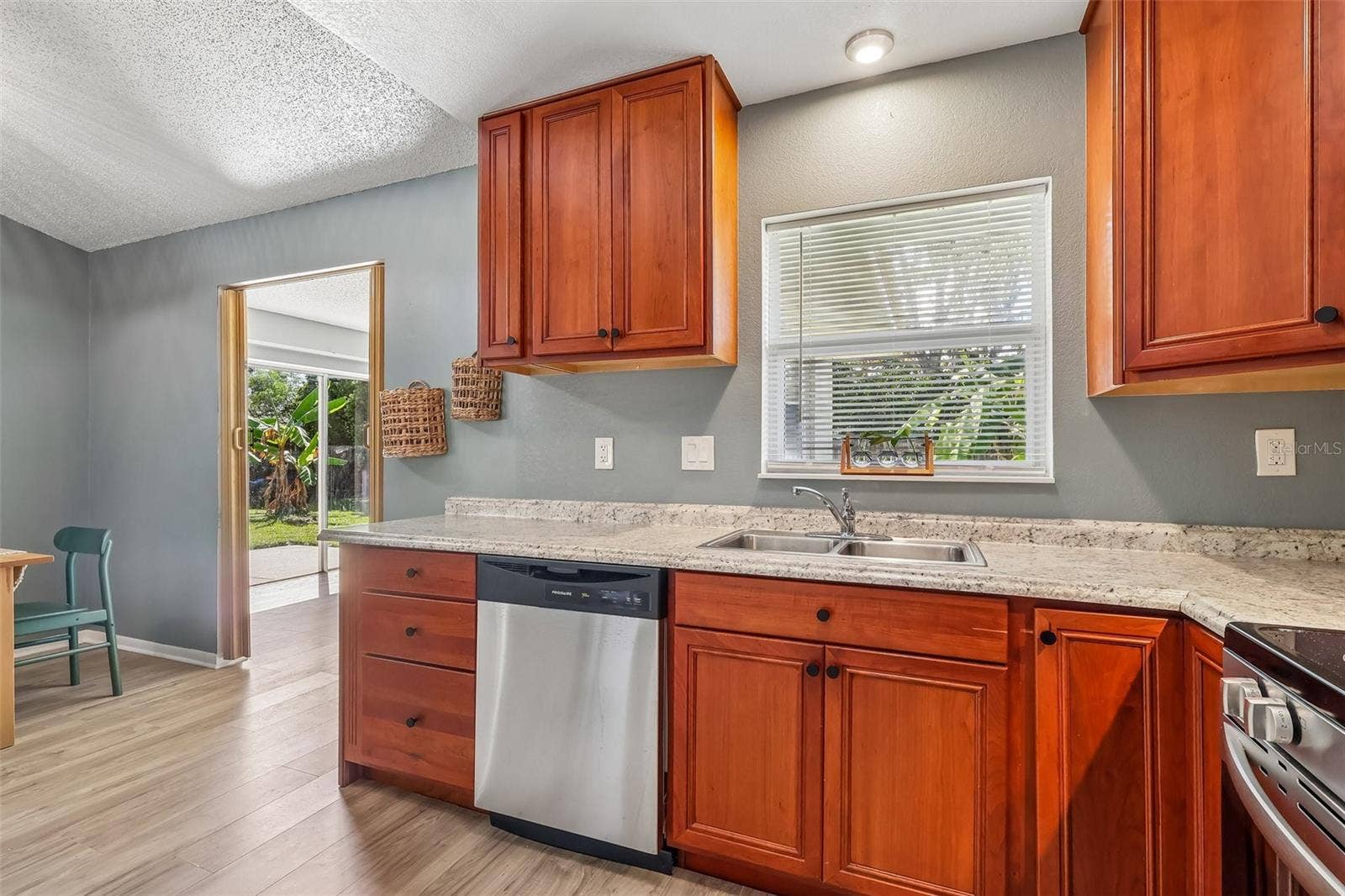 1332 BOREAS DRIVE, Orlando, FL 32822 Everyone loves a window in the kitchen especially over the sink! The doorway tot he bonus room is to the left of the kitchen. This is also the access to the backyard.