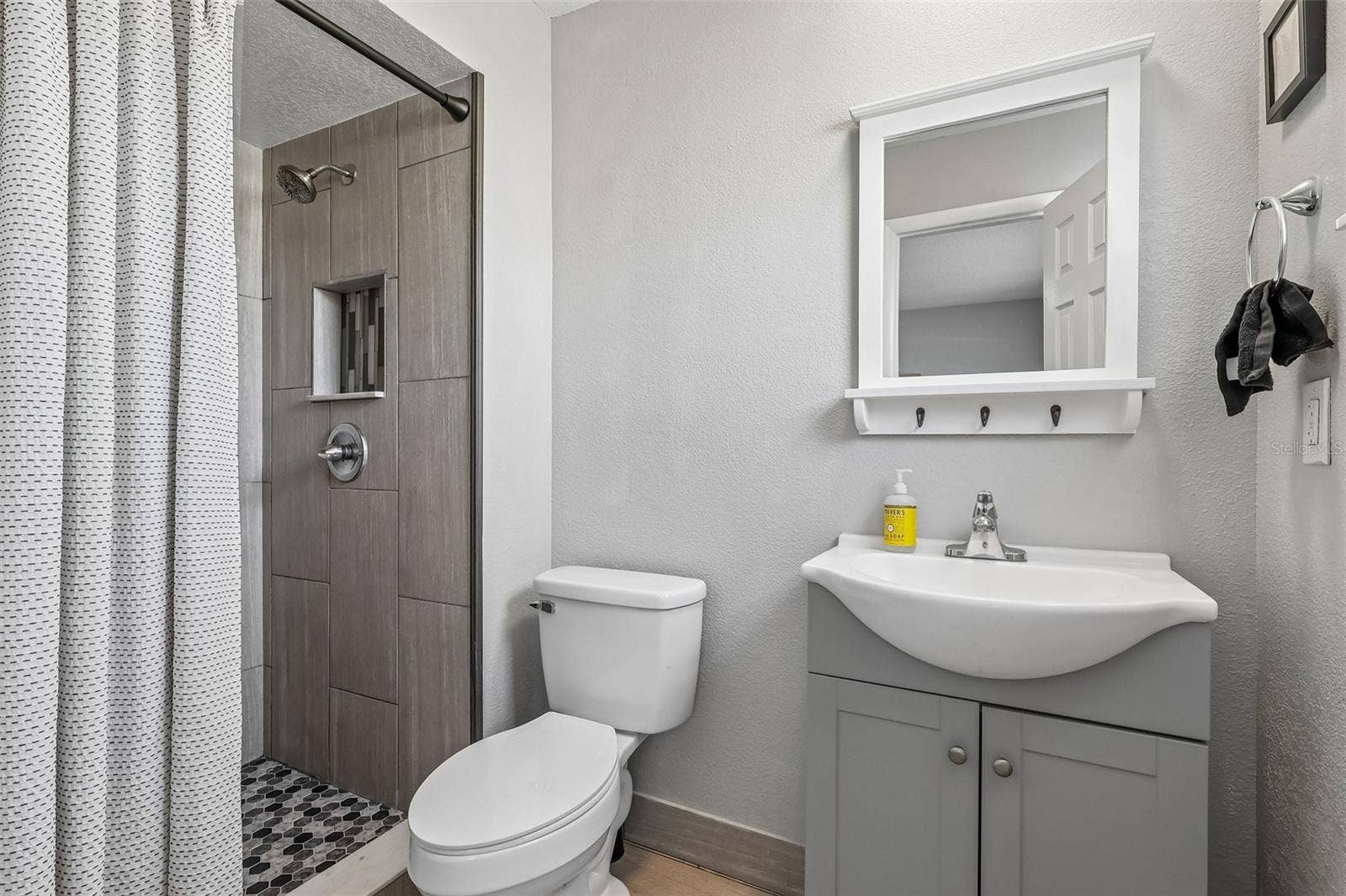 1332 BOREAS DRIVE, Orlando, FL 32822 The primary bathroom has an updated stand-up shower, vanity, and decorative mirror