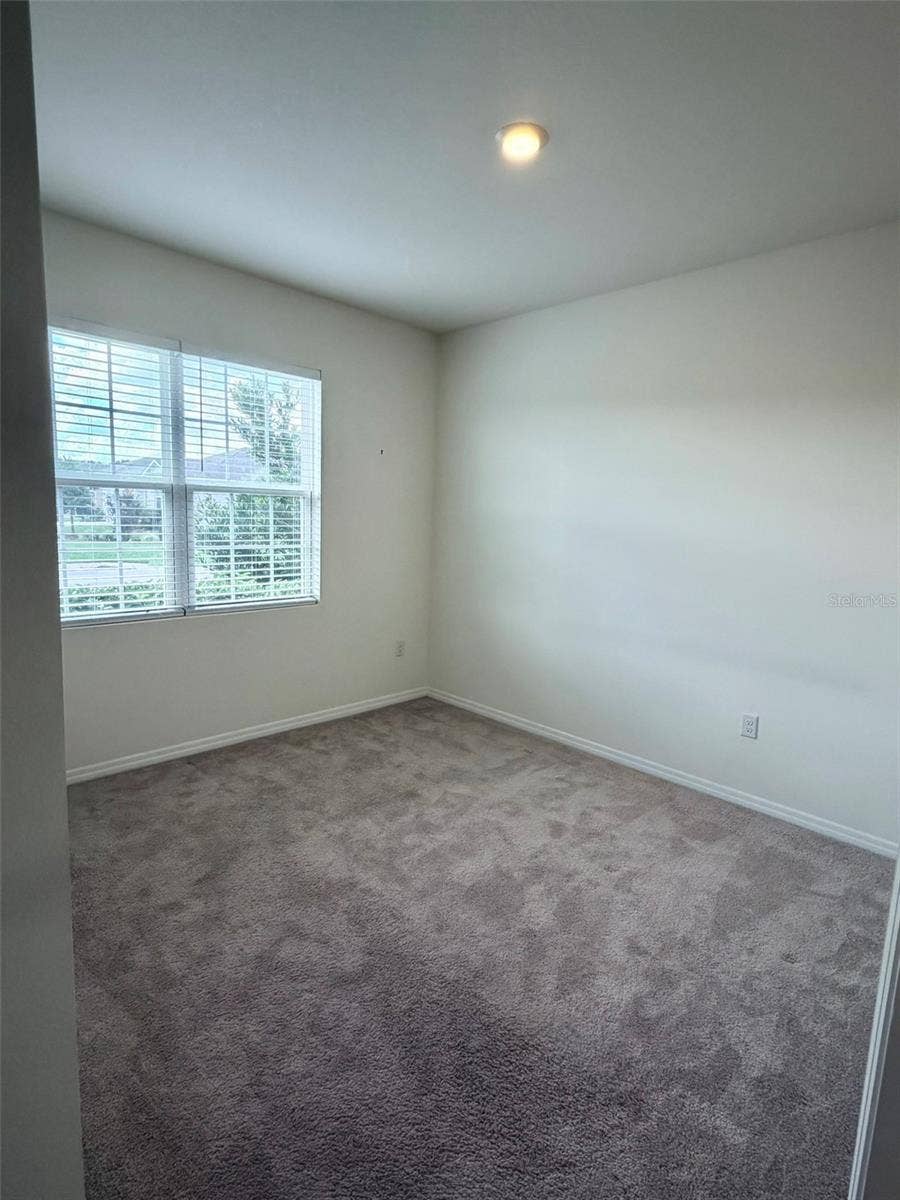 6345 SW 88TH LOOP, Ocala, FL 34476 Front Bedroom with closet and ceiling light.