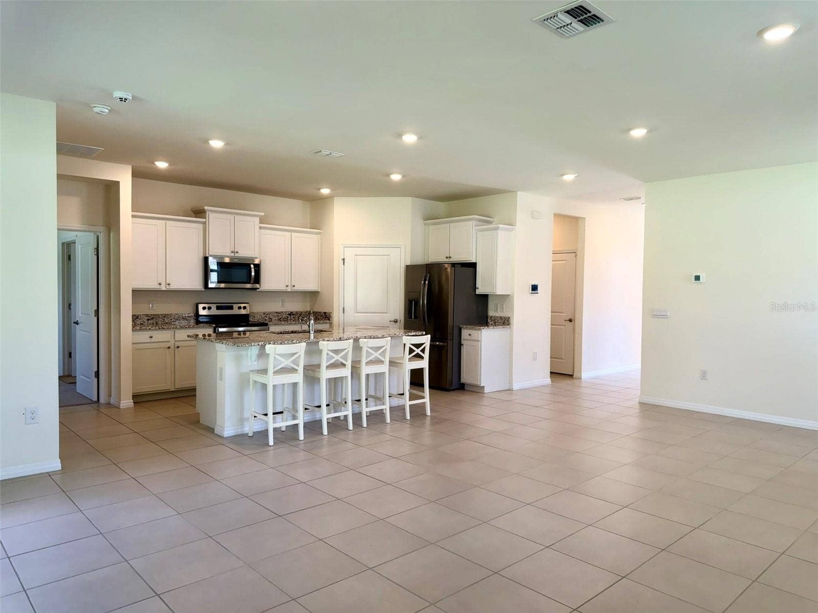 6345 SW 88TH LOOP, Ocala, FL 34476 High ceilings and gourmet kitchen with granite countertops.