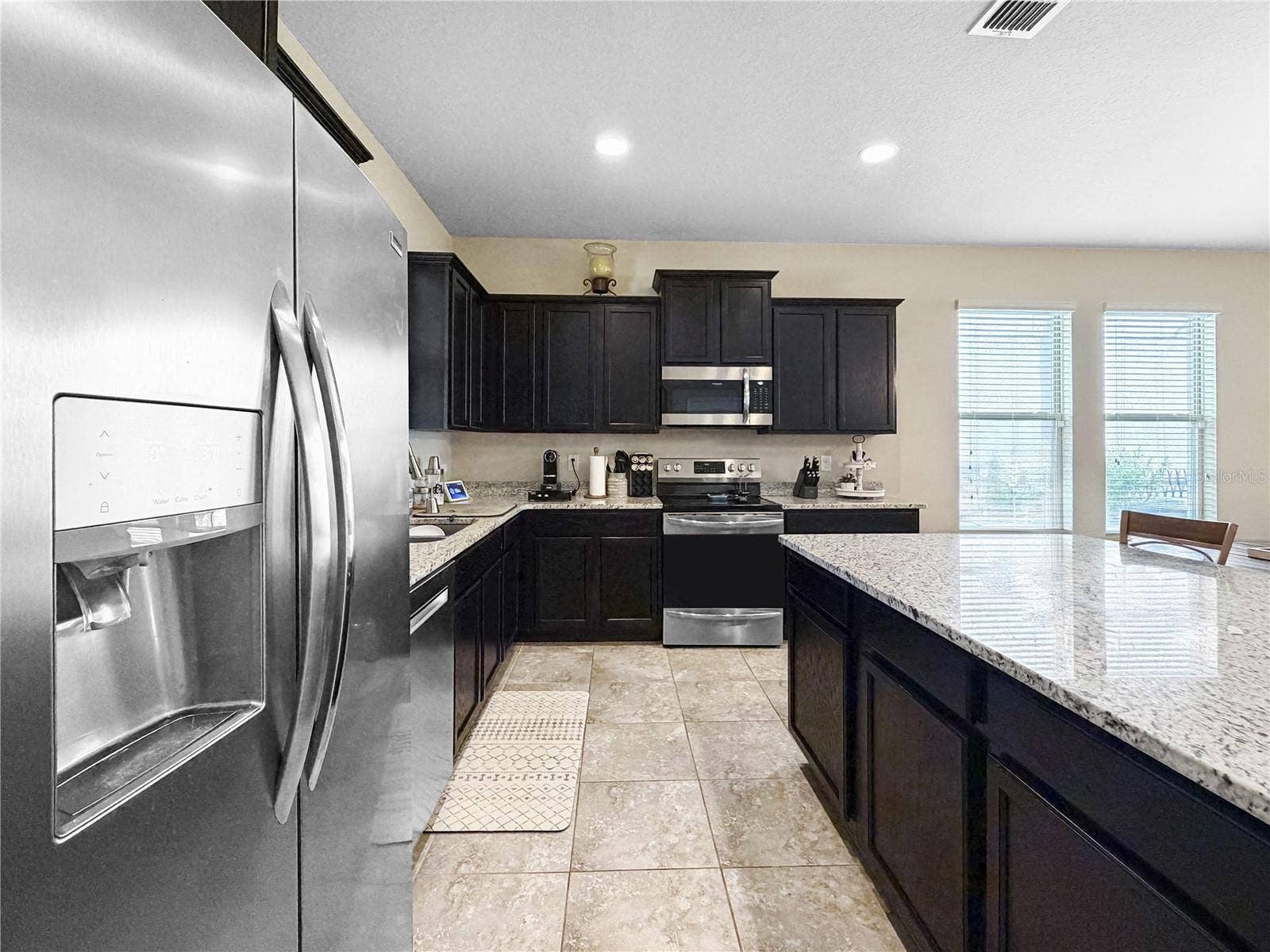 9662 WATERWAY PASSAGE DRIVE, Winter Garden, FL 34787 Classic espresso cabinetry, granite counters and stainless appliances