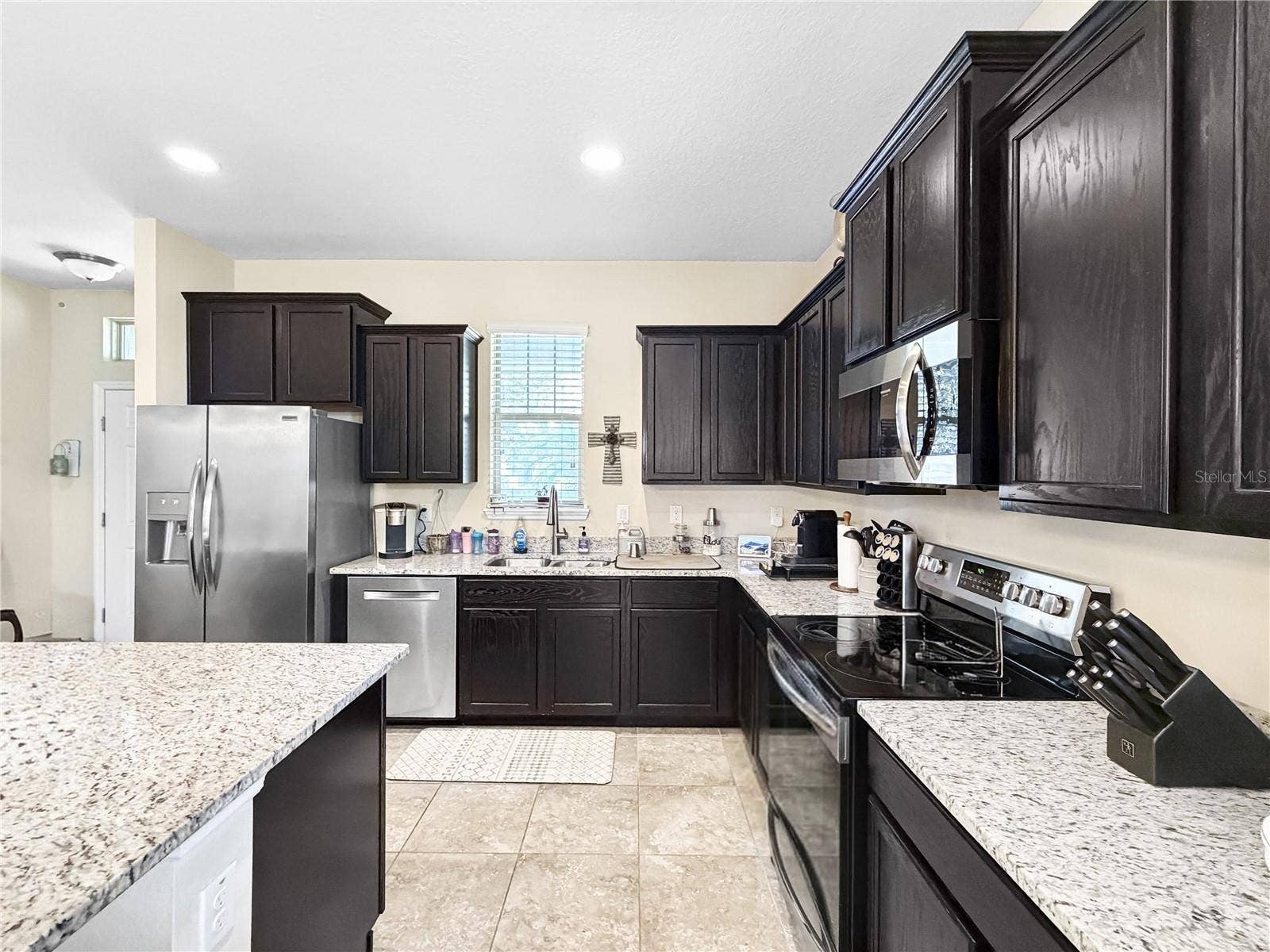 9662 WATERWAY PASSAGE DRIVE, Winter Garden, FL 34787 Classic espresso cabinetry, granite counters and stainless appliances