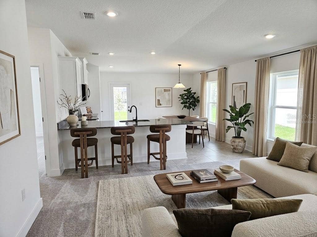 3614 BRIARLYNNE WAY, St Cloud, FL 34773 Great room and kitchen - virtually staged