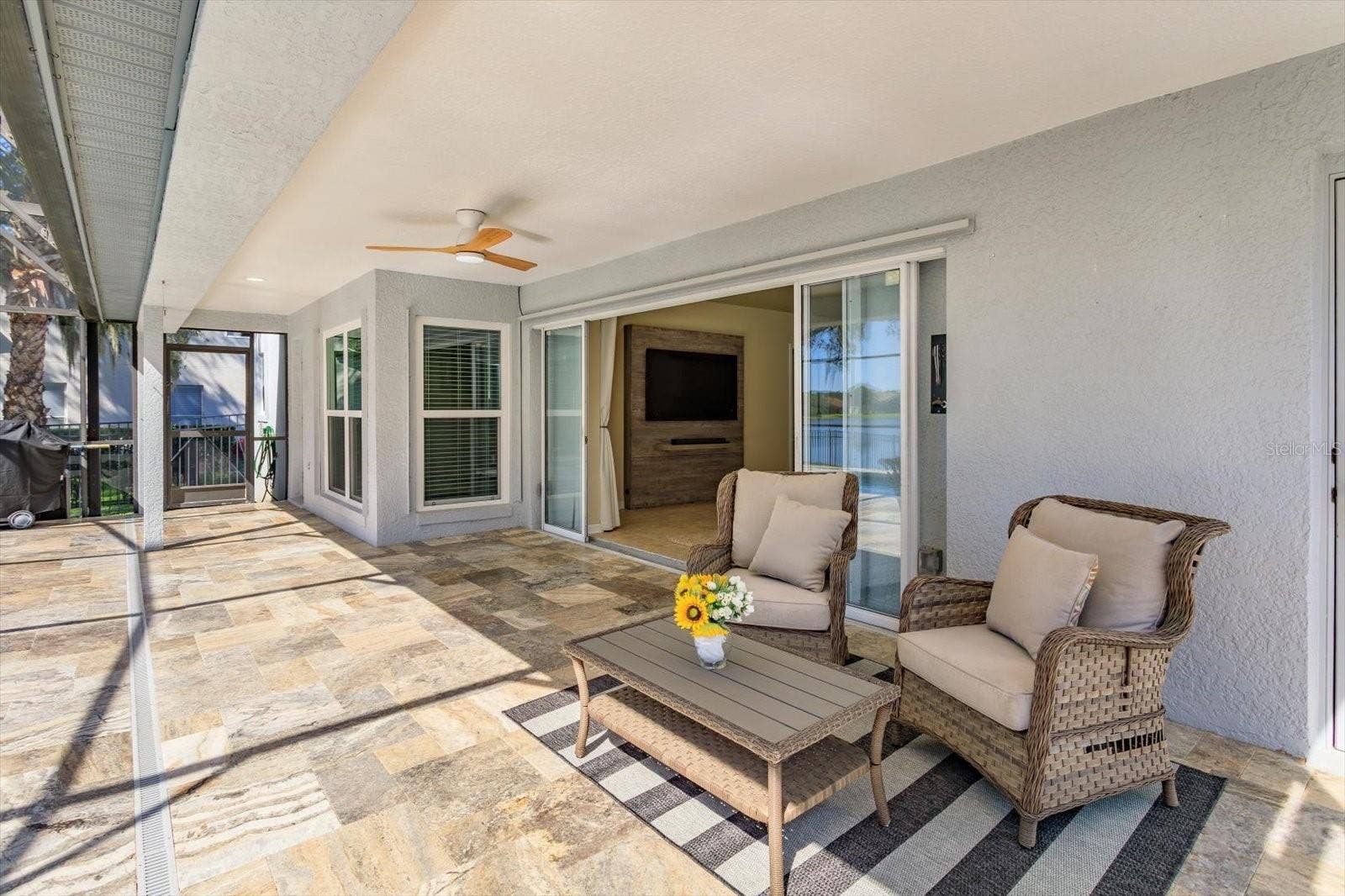 6887 HIDDEN GLADE PLACE, Sanford, FL 32771 Travertine covered porch with double pocket sliding doors