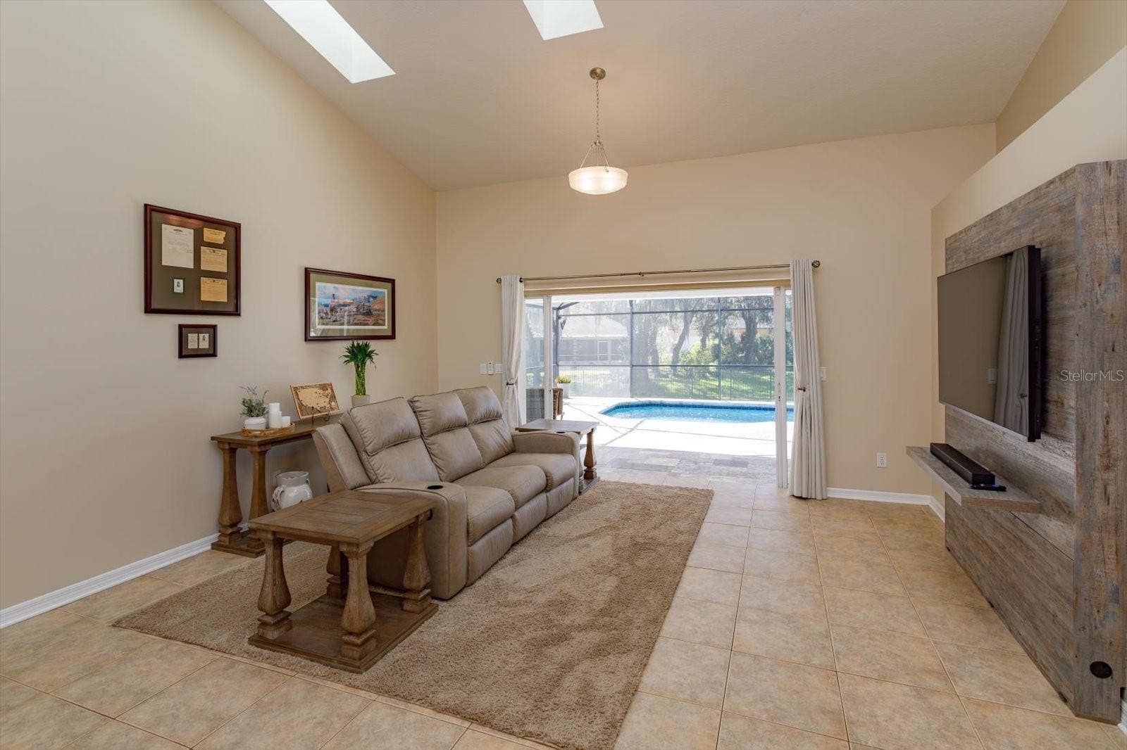6887 HIDDEN GLADE PLACE, Sanford, FL 32771 Freshing painted family room features double pocket sliding doors to the covered porch