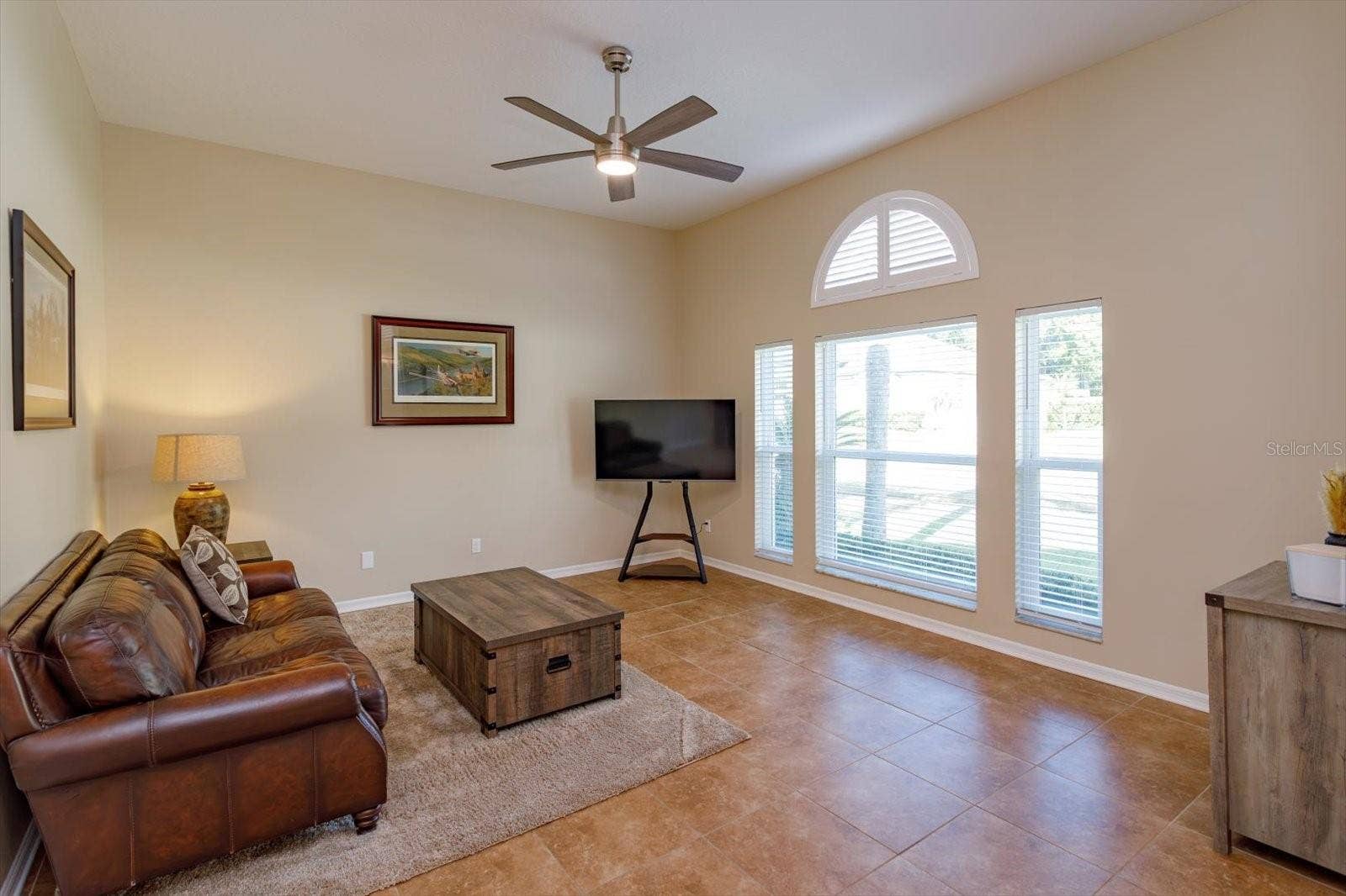 6887 HIDDEN GLADE PLACE, Sanford, FL 32771 Freshly painted living room with new windows and new ceiling fan