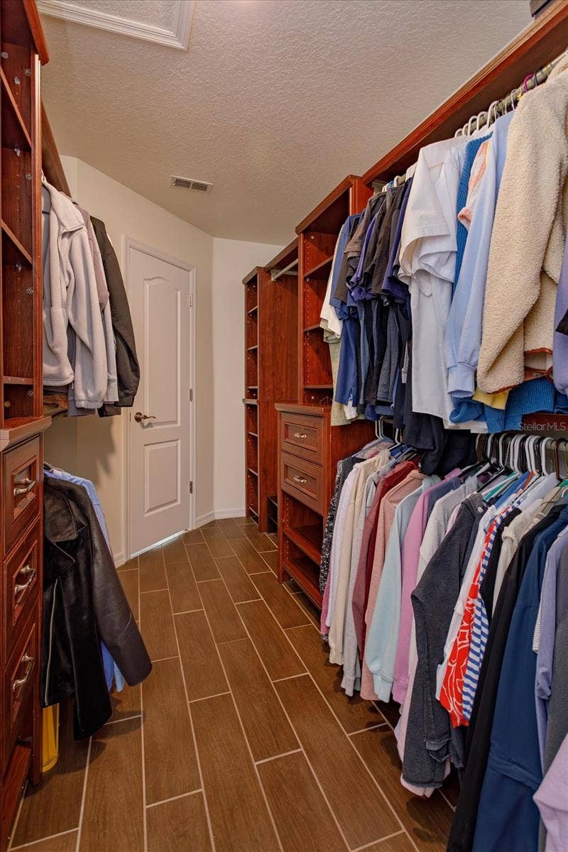 6887 HIDDEN GLADE PLACE, Sanford, FL 32771 Custom walk in closet with floor safe in the primary suite